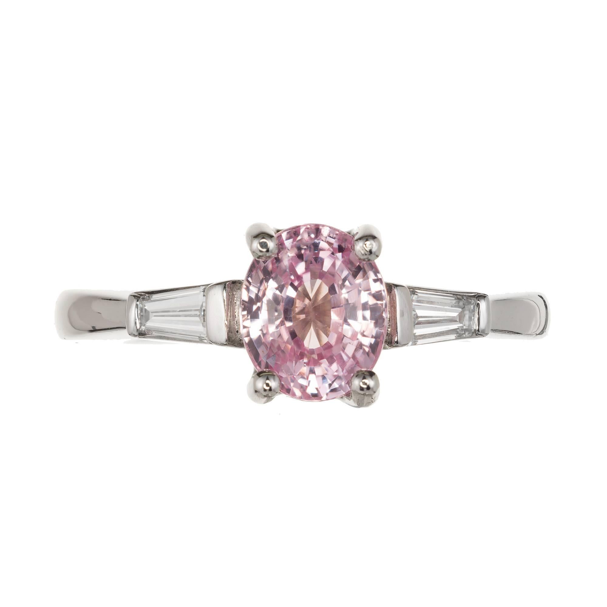 1950's Natural oval pink sapphire and baguette diamond engagement ring. Platinum three-stone setting with tapered baguette sides and a super bright oval natural old European cut pink Sapphire with a hint of purple from Sri Lanka. 

1 oval pink