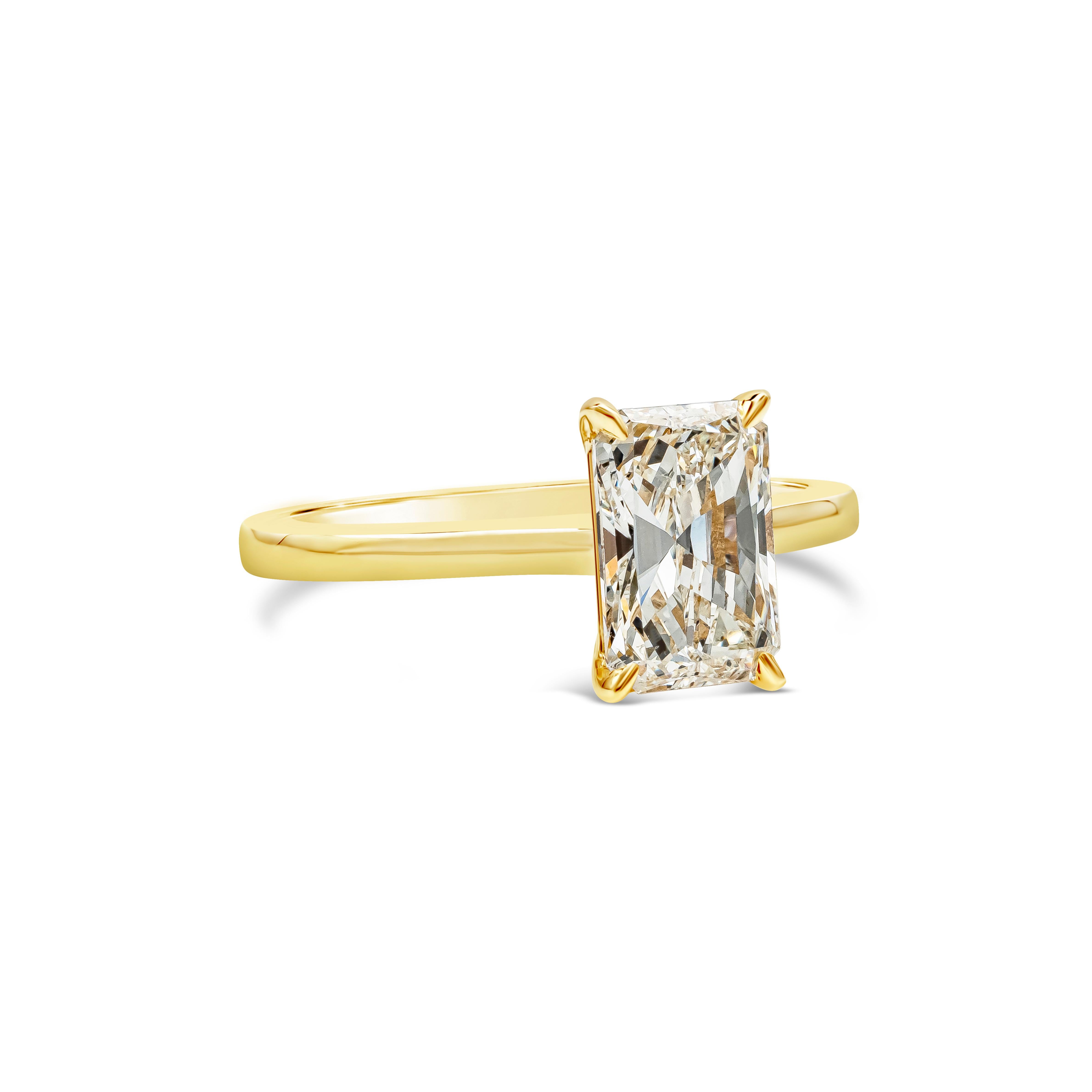 A beautiful engagement ring showcasing a 1.66 carats elongated radiant cut diamond certified by GIA as K color, VS2 in clarity, set in a simple solitaire four prong basket setting and  made in 18K yellow gold. Size 6.25 US and resizable upon