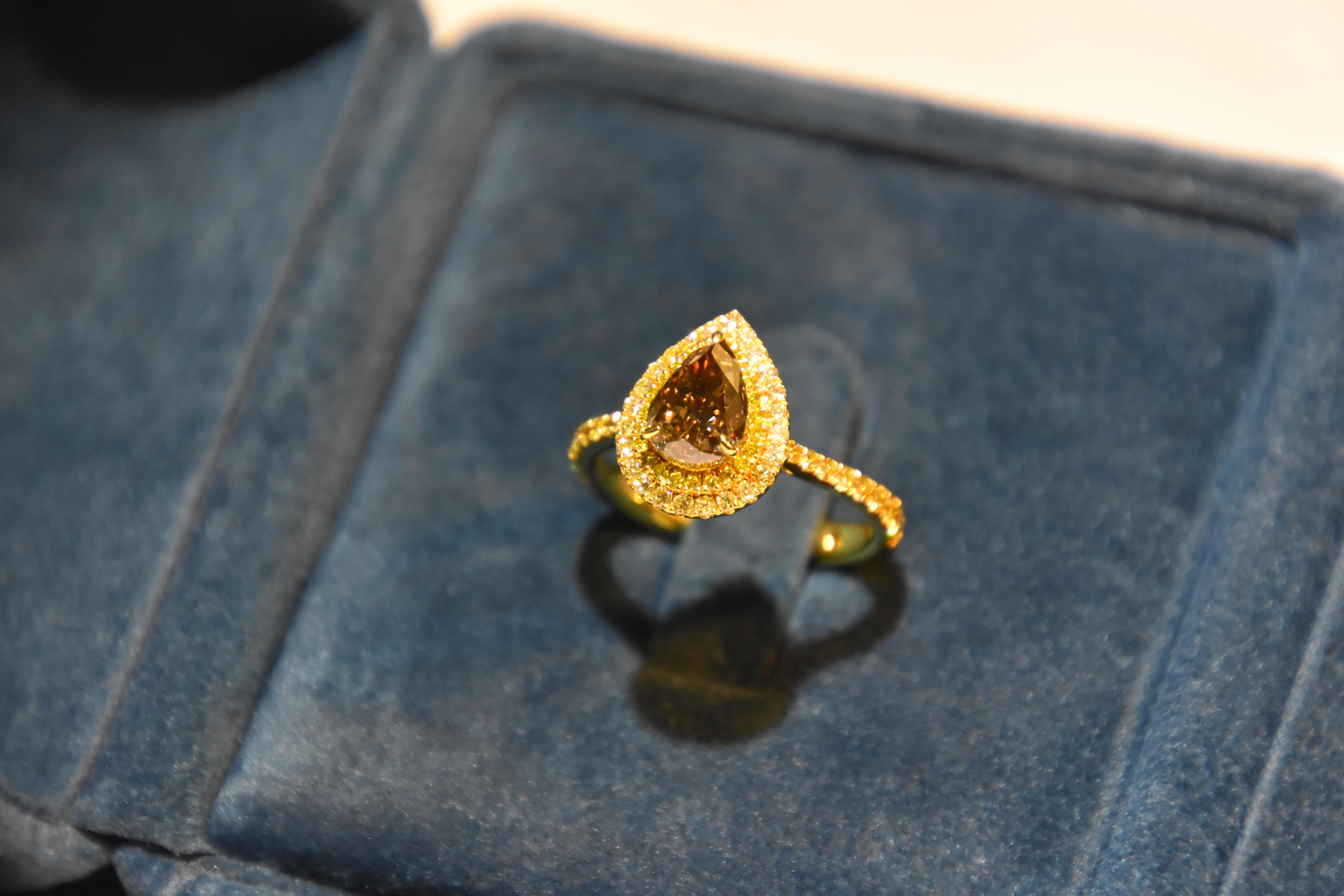 Featuring a 1.66 carat pear shape Fancy dark yellowish brown diamond, finished with yellow diamond in yellow gold. 
Brown and yellow diamond make a good contrast on the ring. 

Center stone certified by world wide known GIA institution.