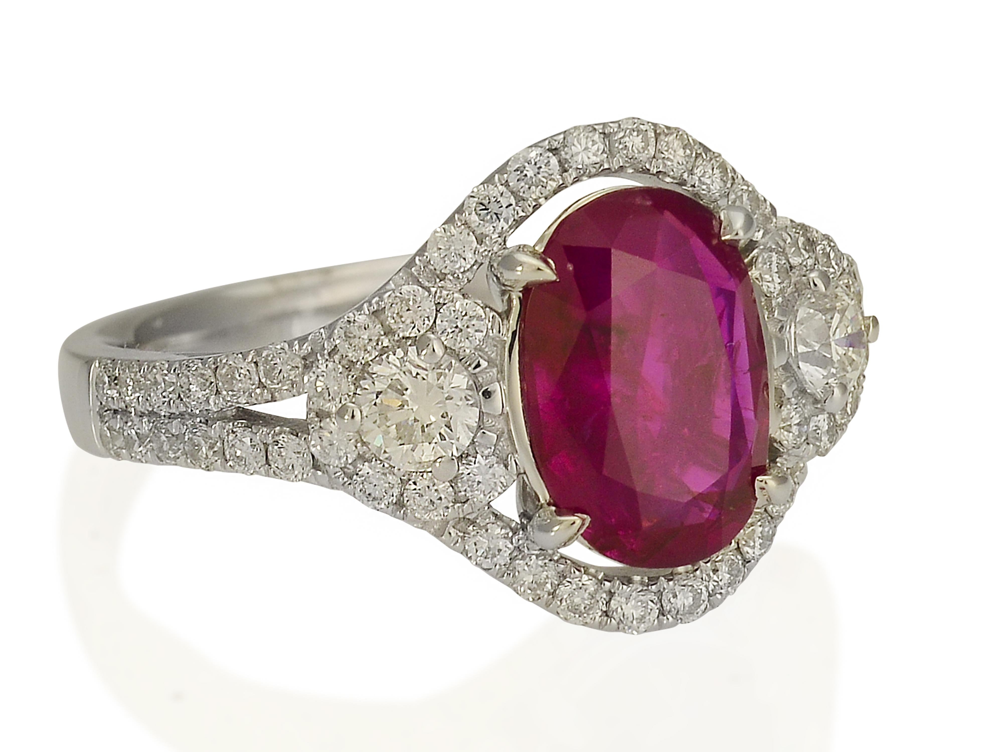 This glistening 18 karat white gold ring features a rare 1.67 carat no heat Burma ruby graded by GIA. 58 round brilliant cut diamonds accent the ruby totaling 0.82 carats of VS clarity and G color. Ring fits finger size 6.5; purchase includes one