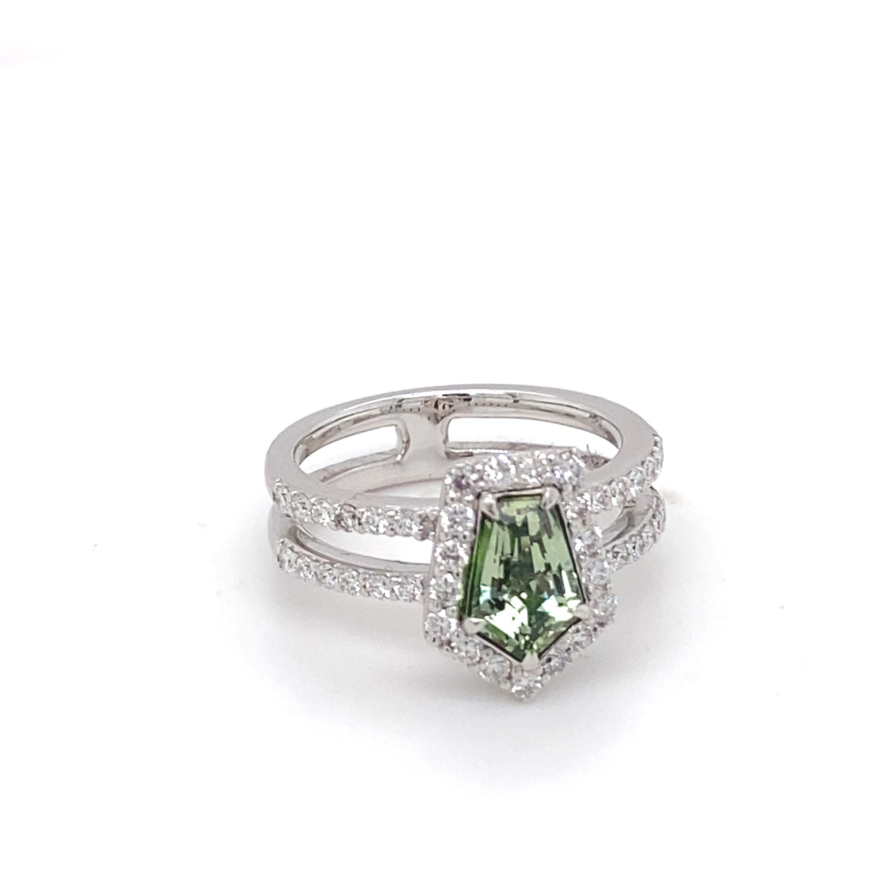 This GIA-certified 1.67 carat pentagonal-shaped yellow-green sapphire ring features a stunning 0.60 carat diamond halo, showcasing a unique and elegant design. The band is beautifully accented with pave-set diamonds, adding a touch of sparkle to the