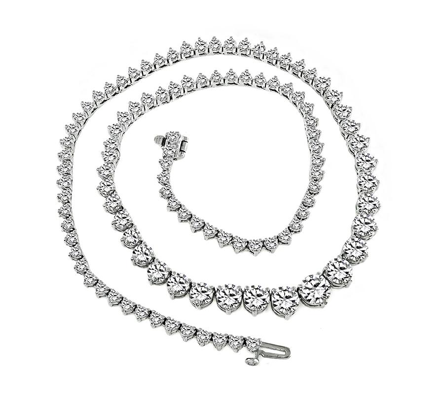 This is an elegant 14k white gold tennis necklace. The necklace is set with sparkling round cut diamonds that weigh approximately 16.75ct. The color of these diamonds is H-J with VS2 clarity. The center diamond is GIA certified that weighs 1.05ct.