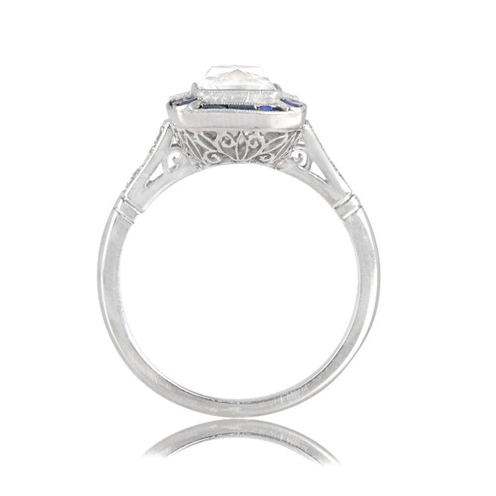 This exquisite engagement ring showcases a GIA-certified antique French cut diamond weighing 1.69 carats, with a J color grade and SI1 clarity, and is beautifully surrounded by a geometric halo of natural sapphires. The ring is handcrafted in