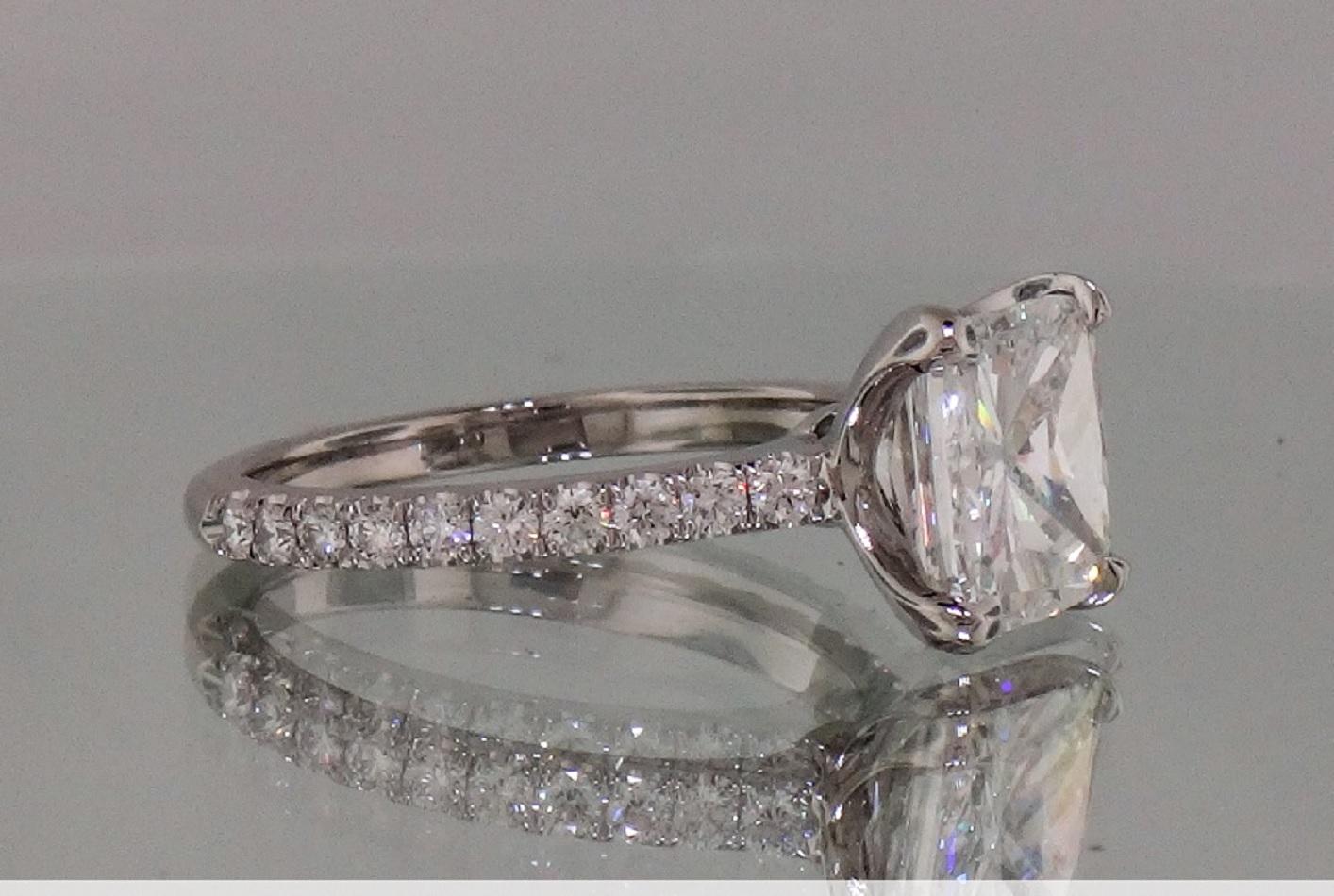 An amazing 2 carat  certified cushion cut diamond ring is completely eye clean, bright white, and it sparkles stunningly with vibrant brilliance! Well cut, the main stone is a 1.62 carat diamond that has sparkle and brightness and well defined