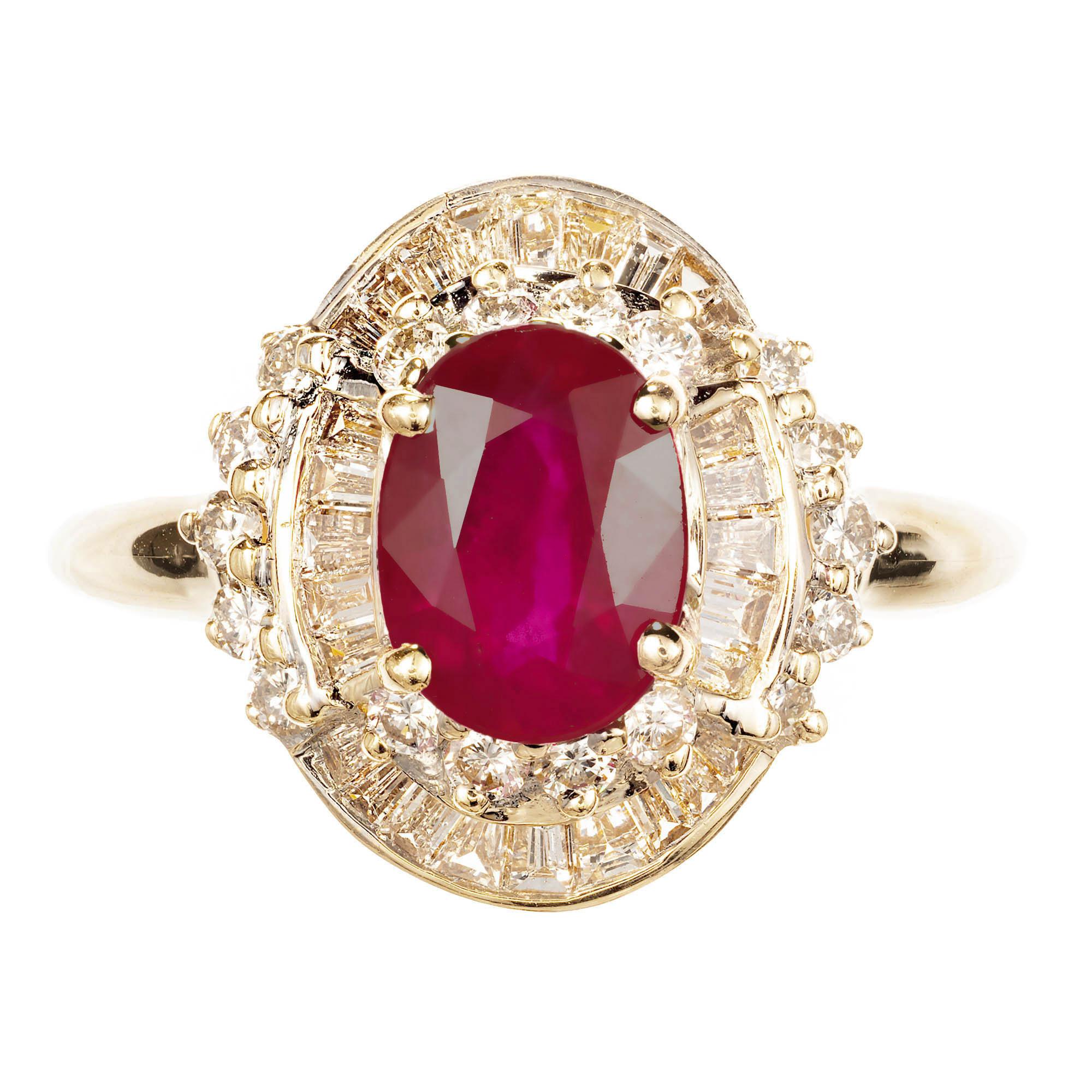 Ruby and Diamond engagement Ring. Oval Ruby set in 14k yellow gold high above 2 rows of alternating round brilliant cut Diamonds and tapered baguette Diamonds set in 14k white gold on a yellow gold shank.

1 oval red Ruby, approx. total weight