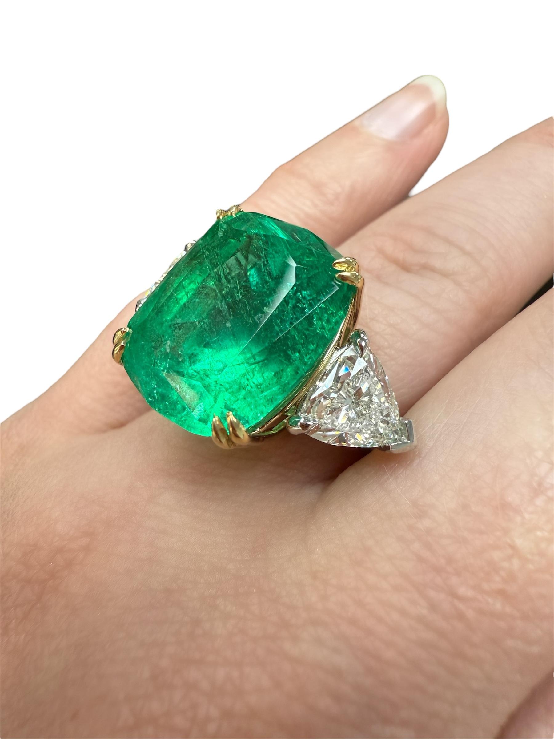 This absolutely stunning ring boasts a gorgeous 17.02 carat emerald, GIA certified Colombian with moderate clarity enhancement and measuring 17.59 x 15.51 x 11.75 mm. Flanked by two top quality trillion cut diamonds weighing 2.86 carats. Mounted