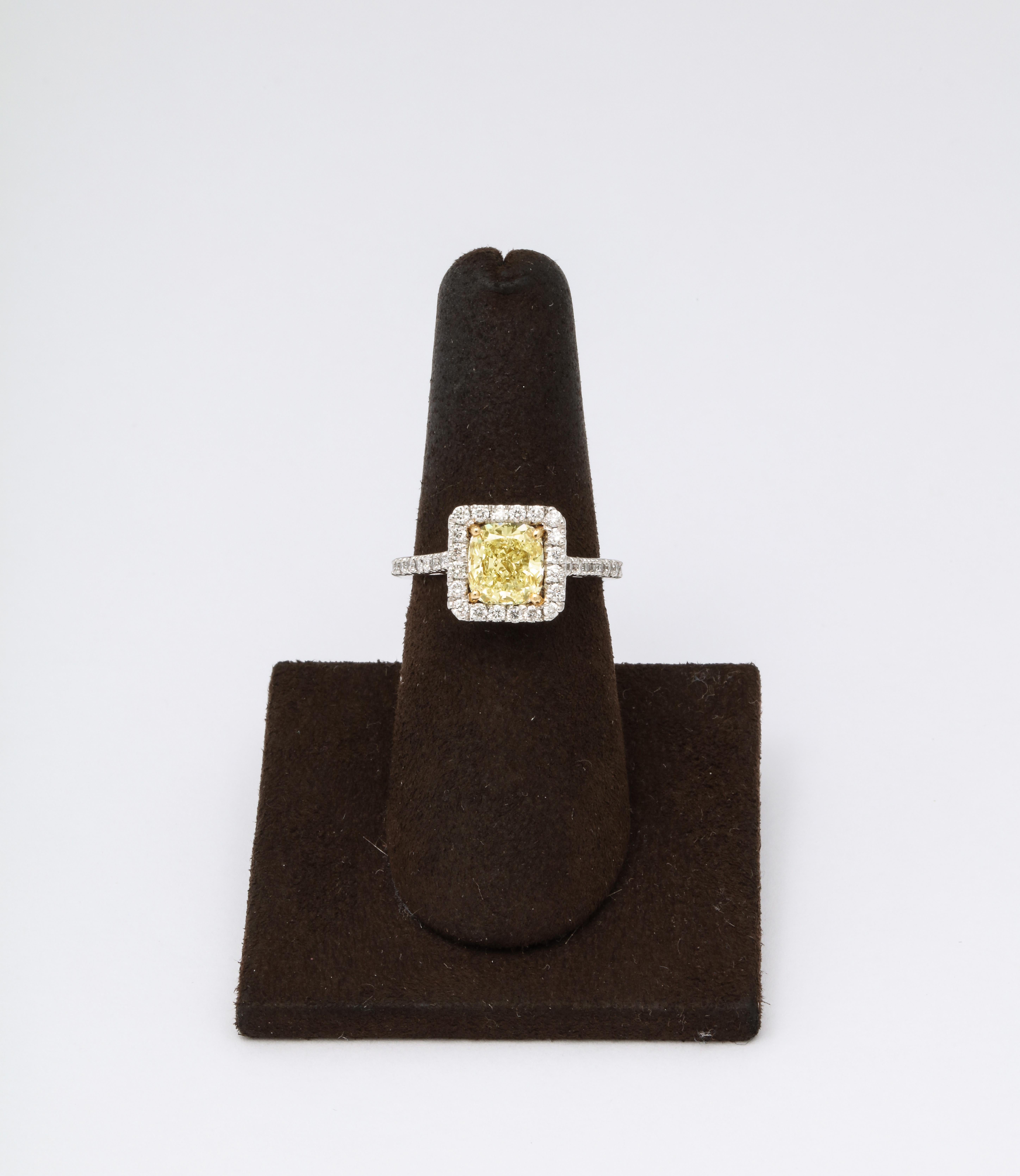 A gorgeous yellow diamond ring!!

1.71 carat GIA certified Cushion cut Fancy Light Yellow, VS1 clarity yellow center diamond.

.52 carats of white round brilliant cut diamonds set in a custom platinum and 18k yellow gold halo mounting. 

Currently a