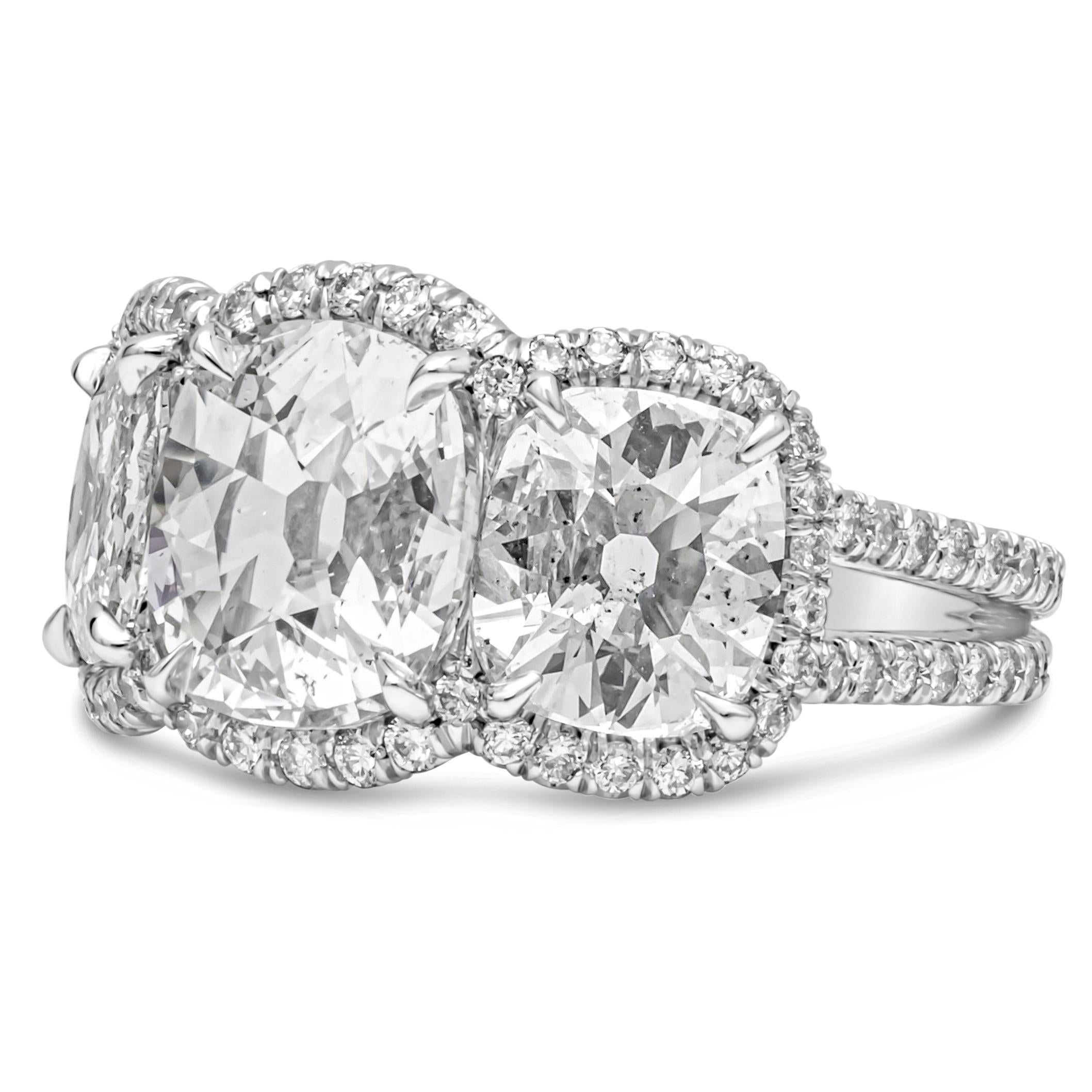Features 1.71 carats cushion diamond in the center certified by GIA as H color and SI2 in Clarity. Flanked by two EGL certified cushion cut diamonds on each side weighing 2.08 carats total, F color, VS2-SI1 in clarity respectively. Accented by a row