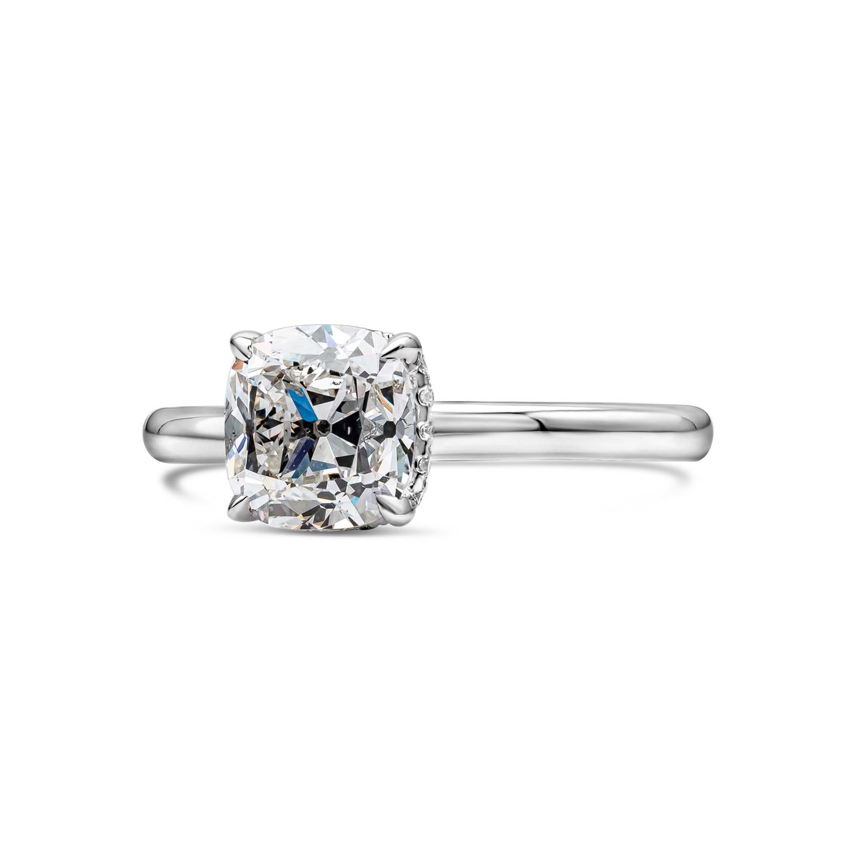 A classic and delicate solitaire engagement ring style showcasing a 1.72 carats antique cushion cut diamond certified by GIA as G color, SI1 clarity. Center diamond set in a classic 18K white gold mounting accented with a brilliant round diamond