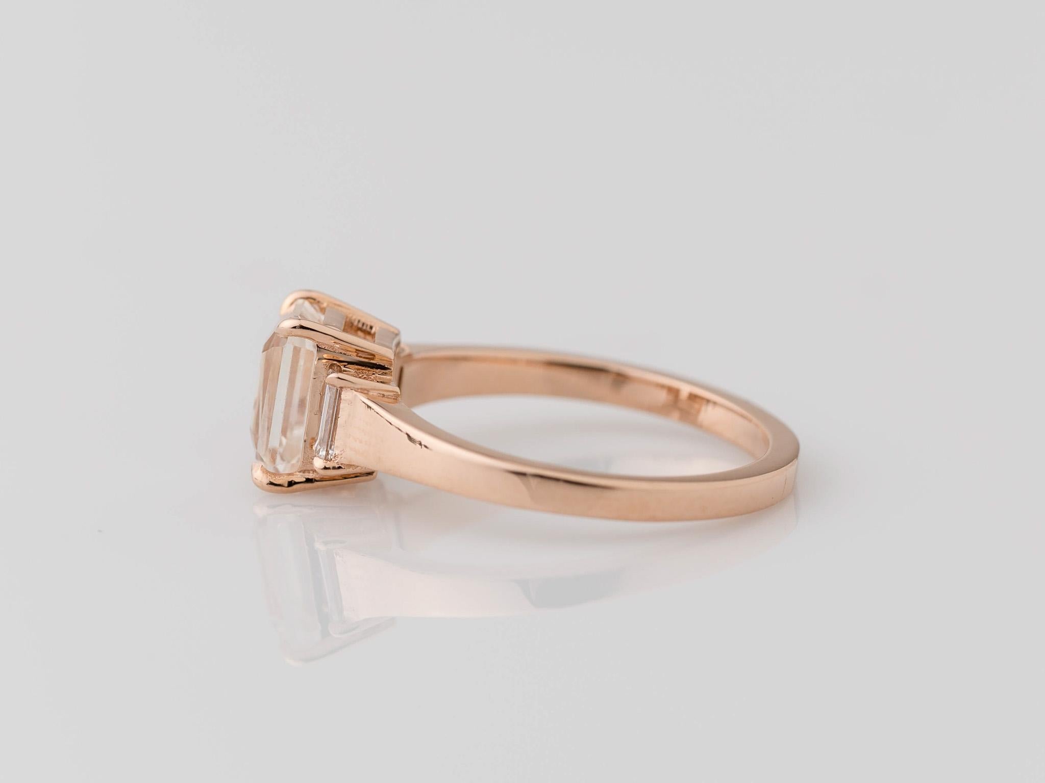 Indulge in understated sophistication with our GIA-certified 1.72 carat Emerald Cut Unheated White Sapphire Ring in 14K Rose Gold. The centerpiece, a pristine white sapphire measuring 7.28x5.24x4.28mm, exudes natural elegance with its non-heated,