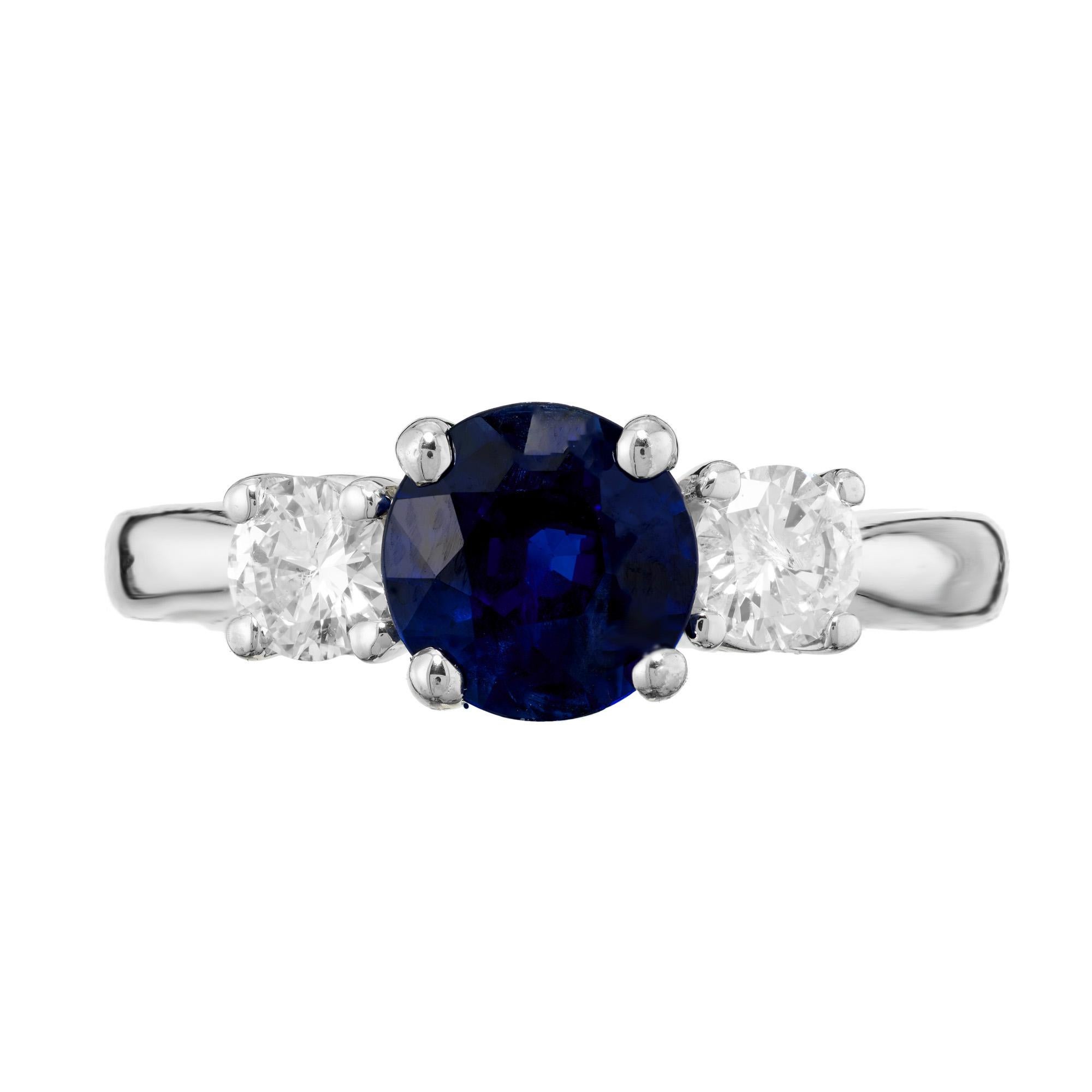 Sapphire and Diamond three stone engagement ring. At the center is a 1.32ct round sapphire, mounted in a 14k white gold three-stone setting. Accented with 2 round diamonds. The sapphire is certified by the GIA as natural, no heat.  

1 round