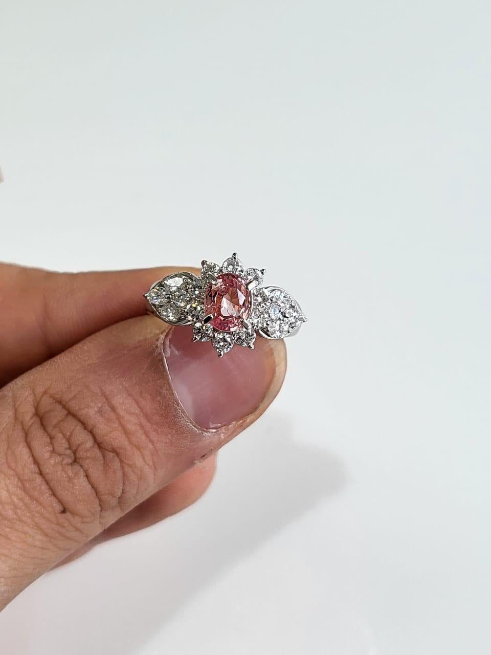 A very gorgeous and one of a kind, Padparadscha Sapphire Engagement Ring set in PT900 & Diamonds. The weight of the Padparadscha Sapphire is 1.74 carats. The Padparadscha Sapphire is completely natural, without any treatment and is of Ceylon (Sri