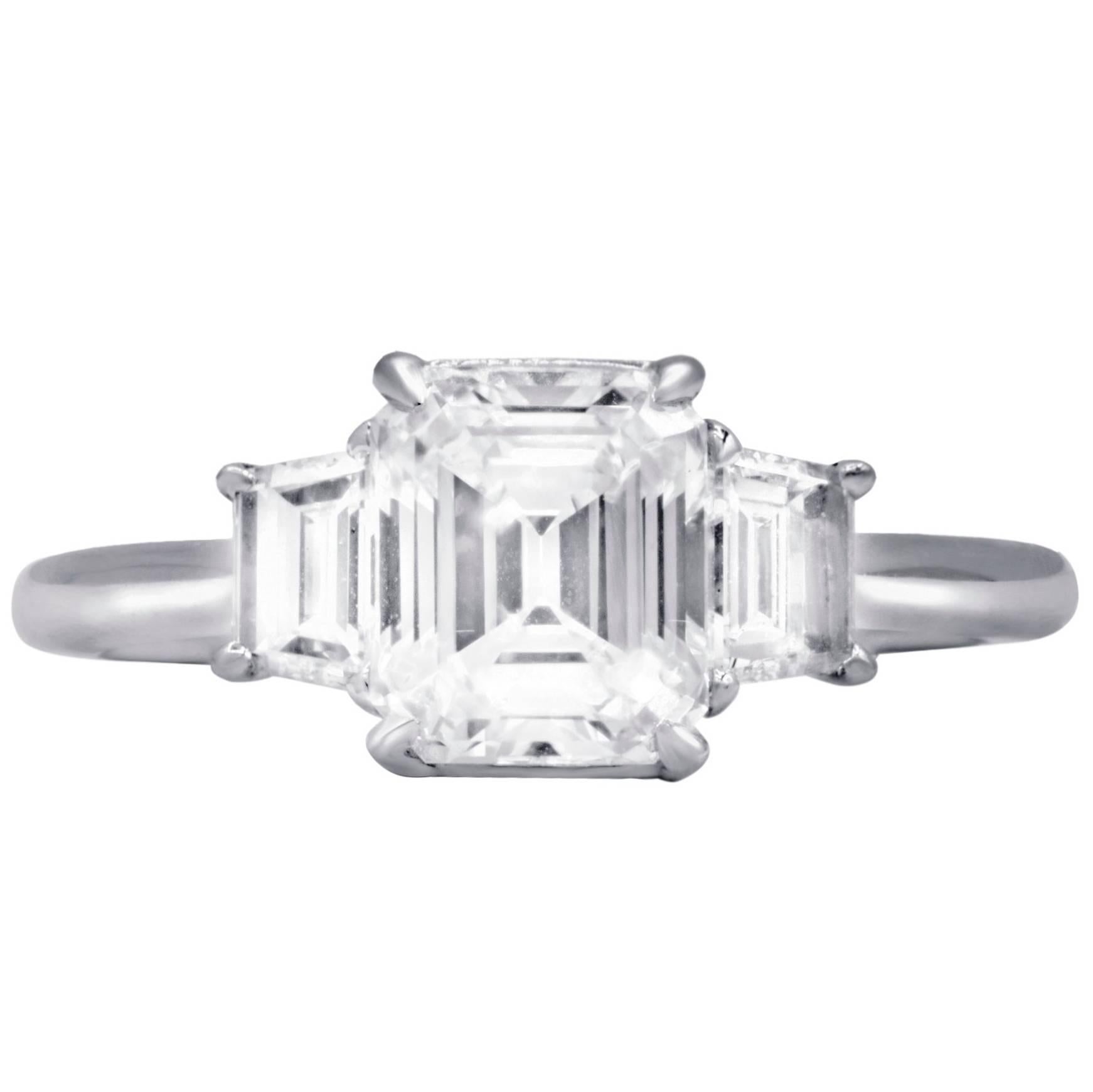 Elegant three stone diamond engagement ring  with  GIA certified emerald cut diamond in the center,weighing 1,75 cts E color/VS1 clarity set with two additional side emerald cut diamonds with total weight 0.64 cts.The mounting is platinum.

•