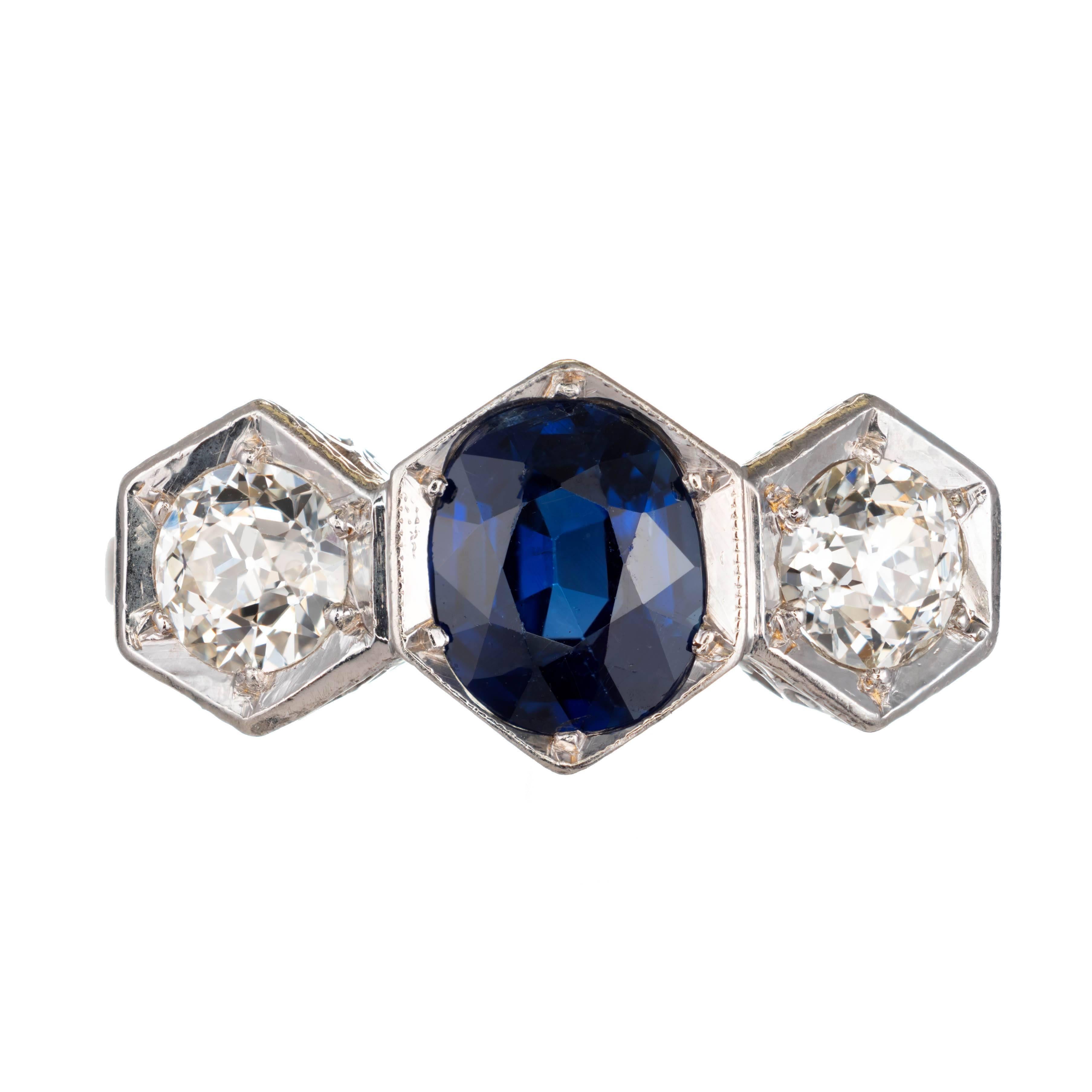 Art Deco Oval sapphire and old euro diamond engagement ring. Three-stone setting in platinum with a center sapphire and two side diamonds. open flower scroll work.  

1 Oval blue sapphire no heat 7.14 x 5.65 x 3.65 approximate 1.15 carat GIA