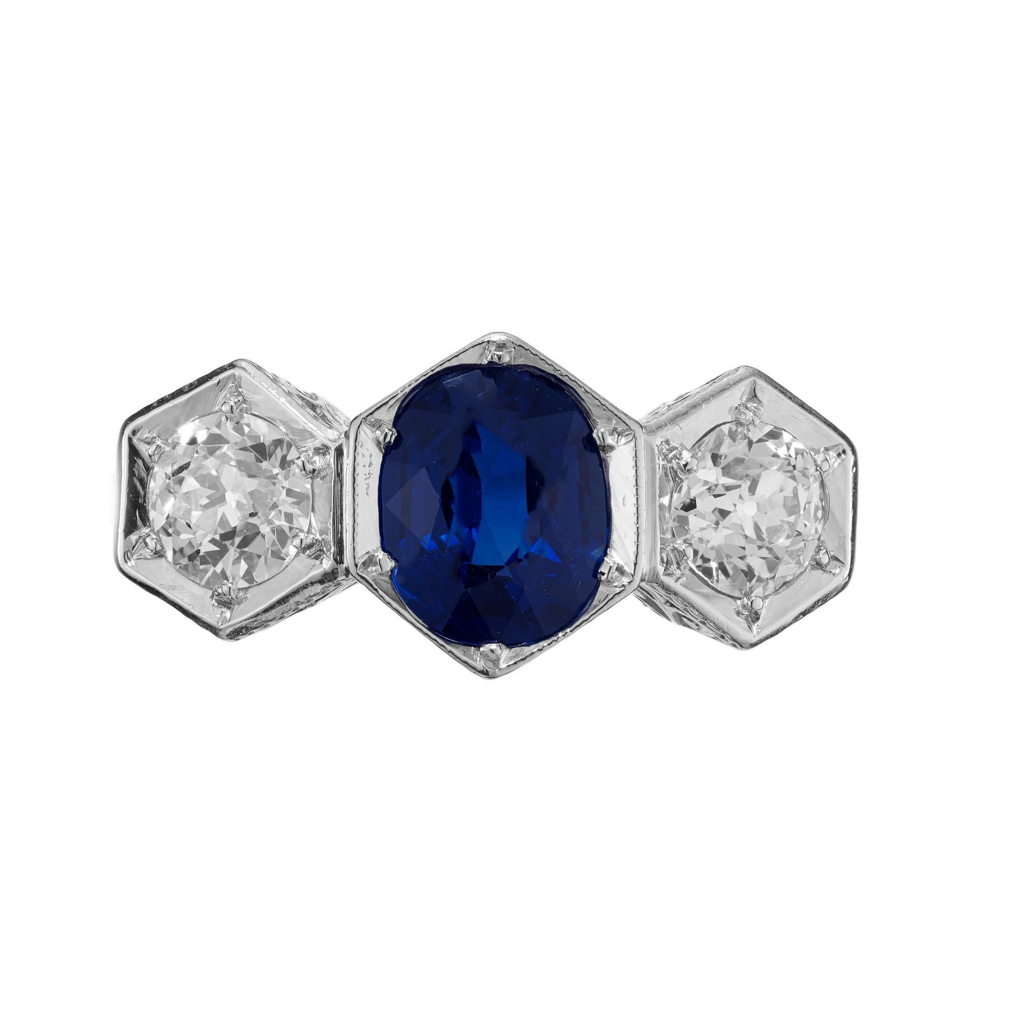 GIA certified 1.15 carat oval sapphire in the center of two .60ct old European diamonds in a beautiful art deco platinum engagement ring. This stunning bright blue sapphire is natural with no indications of treatments in a setting that has