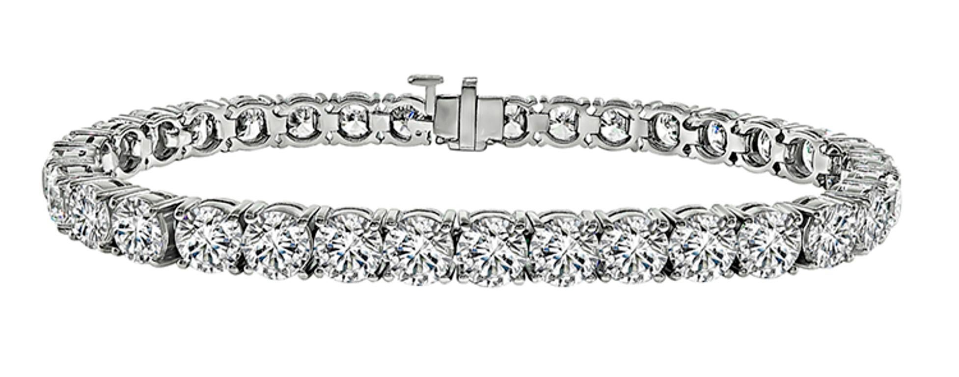 This one-of-a kind 18k white gold tennis bracelet features sparkling GIA certified round cut diamonds that weigh 17.54ct. The color of the diamonds is graded from E-G with SI-SI2 clarity. A copy of the certificates is available upon req uest. The