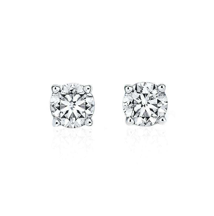A perfectly matched pair of round, near-colorless diamonds are secured in gold four-prong settings with guardian backs and posts for pierced ears. Each earring weighs 0.87 carat and 0.89 carat, for a total diamond weight of 1.76 carats. 
Accompanied