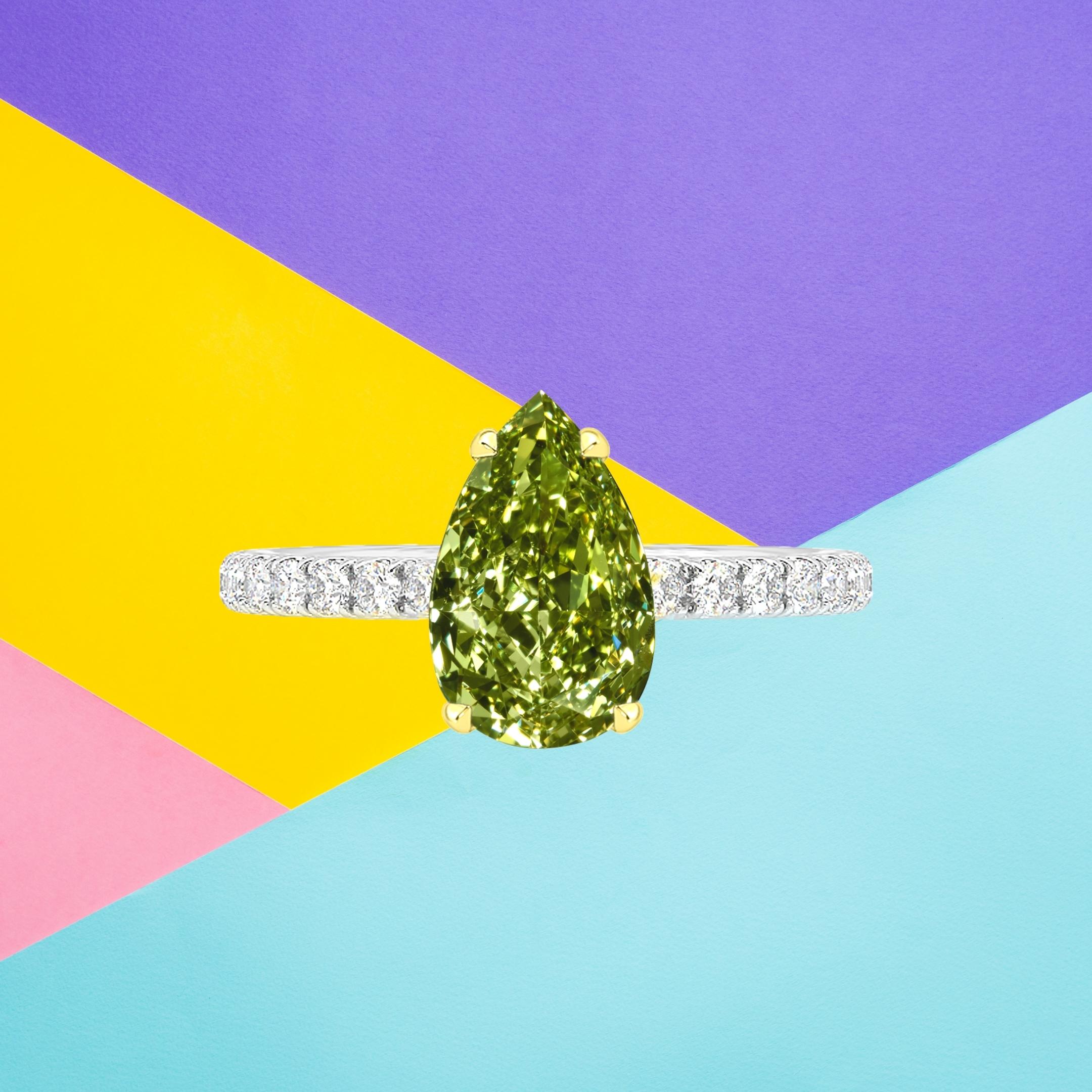 This pear shape diamond weighs 1.76 carat and is certified 'Fancy Deep Grayish Yellowish Green' color by the Gemological Institute of America. The GIA has also assigned a VS1 clarity grading to the stone. The diamond has been inscribed with the