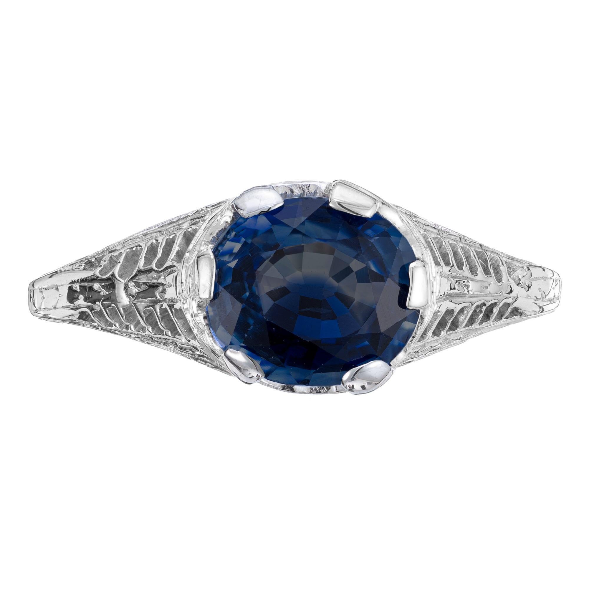 1930's Art Deco sapphire engagement ring. GIA certified as simple heat only, this oval brilliant cut 1.77ct sapphire is mounted sideways in a 14k white gold detailed filigree setting. The sapphire is a rich deep blue, it is secured with with six
