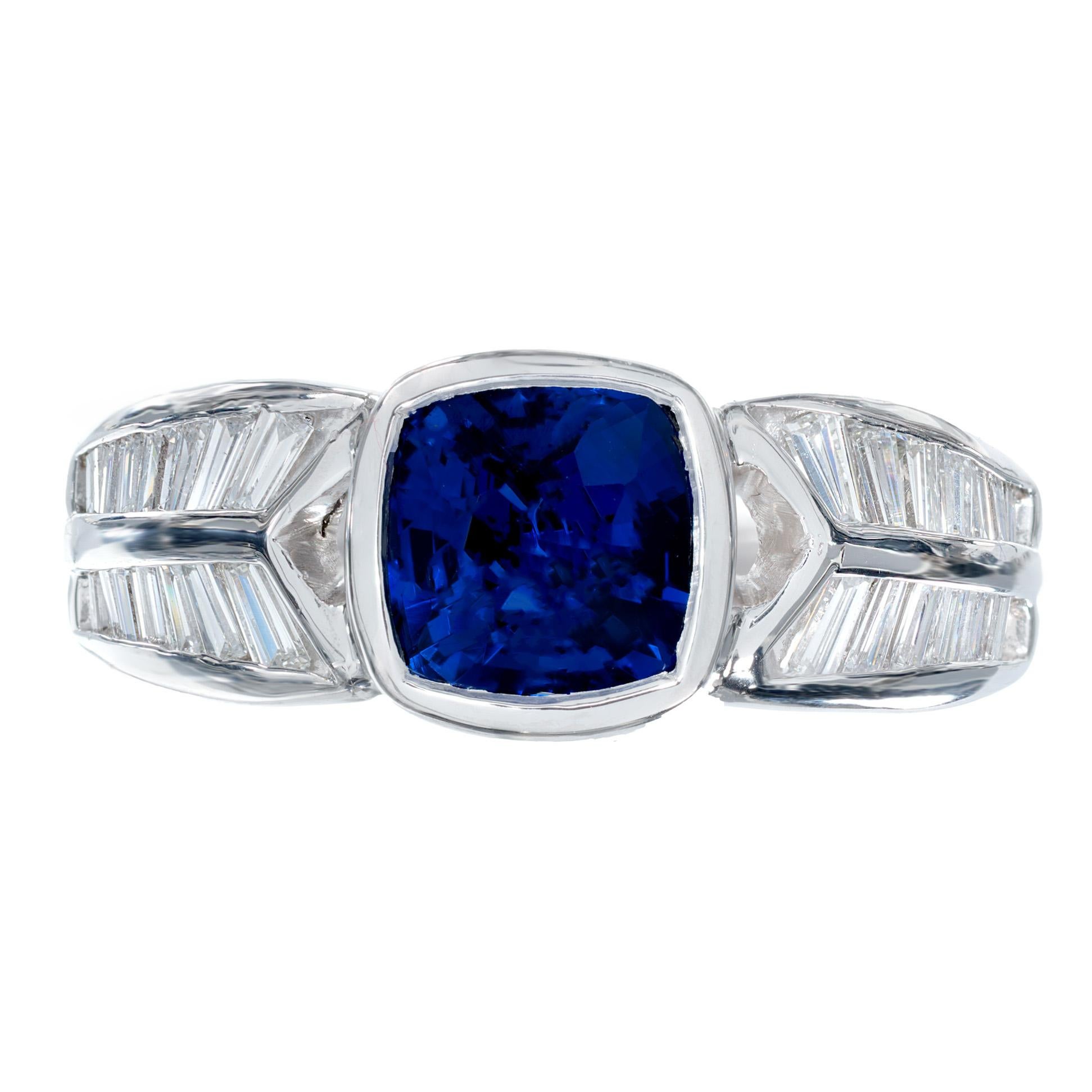 1950's bright blue sapphire and diamond engagement ring. GIA certified cushion cut bezel set sapphire center stone. Graded, natural, no heat and its origin being Madagascar.  Set in a platinum setting with 28 baguette diamonds along each side of the