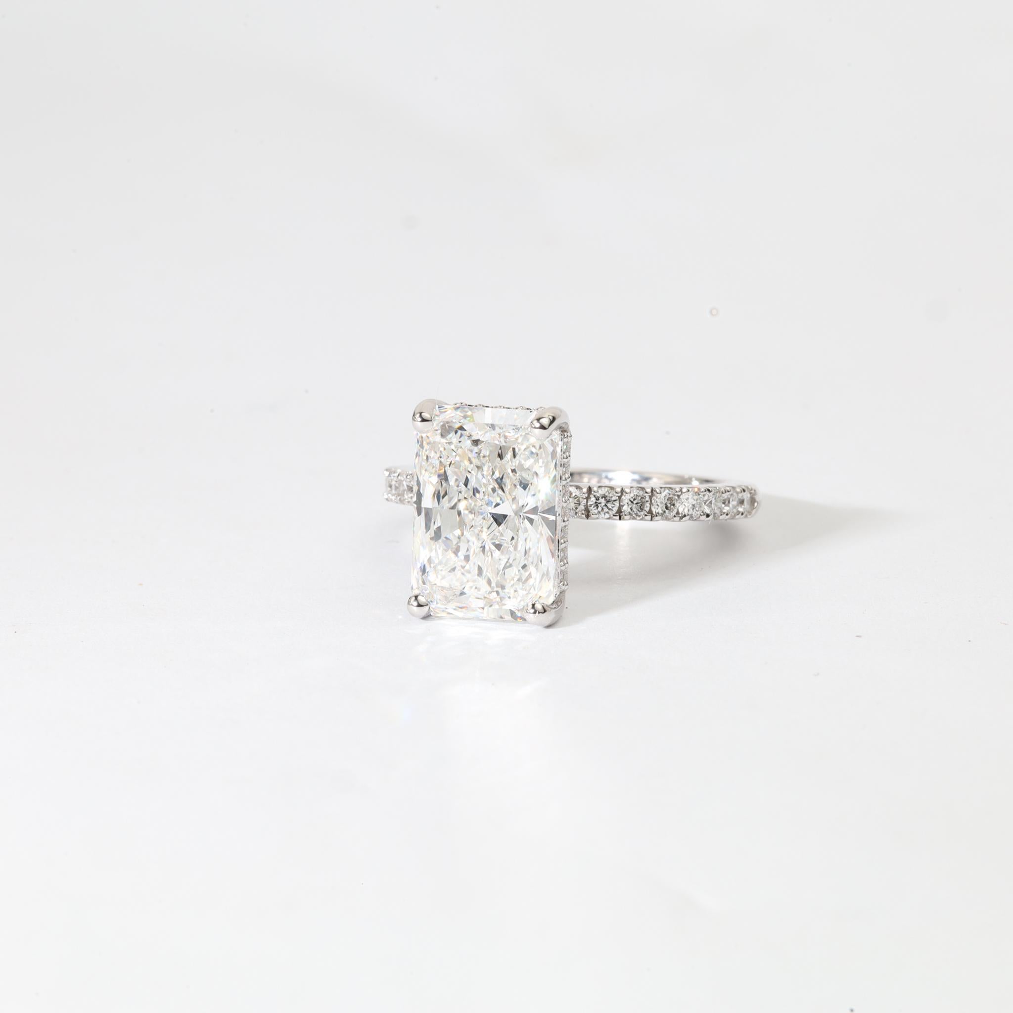 A Statement of Radiant Grandeur.

Exquisite in form and bold in brilliance, this masterfully designed engagement ring features a breathtaking 4.10ct natural radiant-cut diamond, certified by GIA for its VVS clarity and luminous H color. The