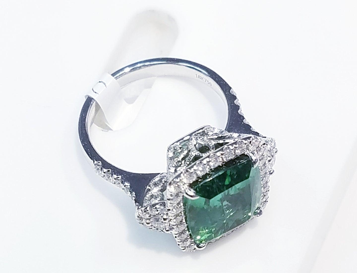 GIA Certified 18k Wt. Gold Cushion Cut Blue-Green Tourmaline and Diamond Ring
7.74 Carats of Blue-Green Tourmalines
0.73 Carats of Natural Diamonds
18 Karat White Gold
Antique Cushion Cut 
GIA Certified
