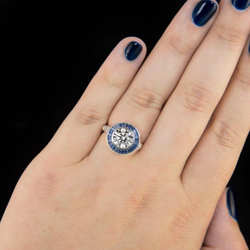 Modern GIA Certified 1.80 Carat Round Cut Blue Sapphire Halo Ring For Sale