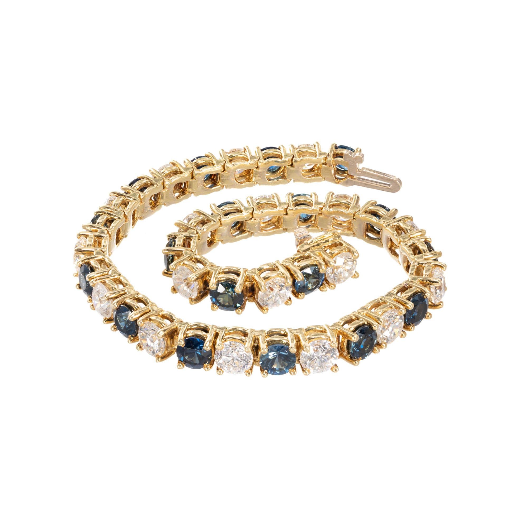 Hinged link sapphire and diamond 18k yellow gold bracelet alternating bright white diamonds and deep blue Sapphires. Hidden build in catch and underside safety.

18 round brilliant cut diamonds, approx. total weight 8.00cts, H, VS1
18 round bright