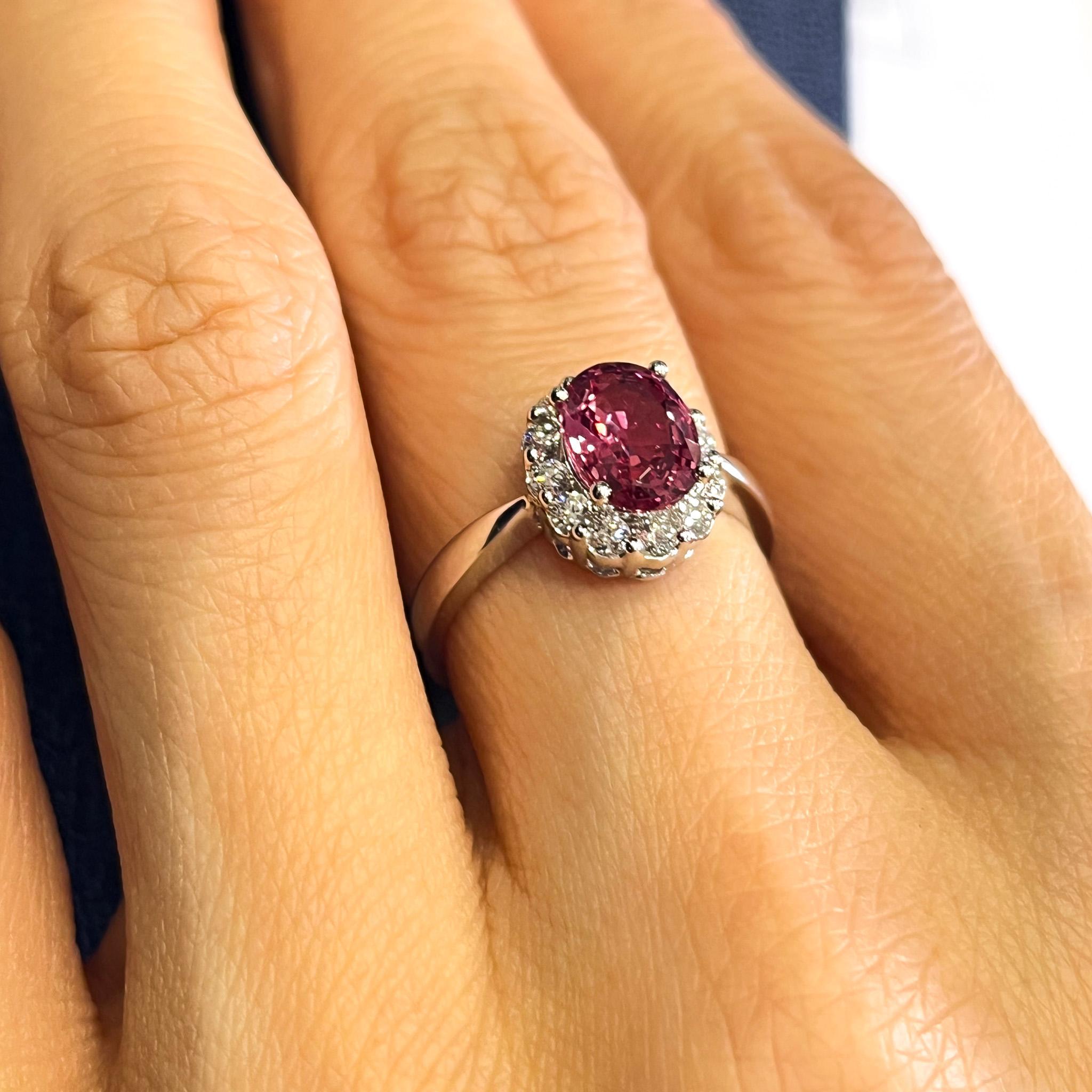 This GIA-certified ring showcases a rare, no-heat 1.81 carat Padparadscha color sapphire in a classic oval halo design. Surrounded by natural round diamonds and set in polished 18K white gold, this elegant piece is made to last. Ring size 6.5,