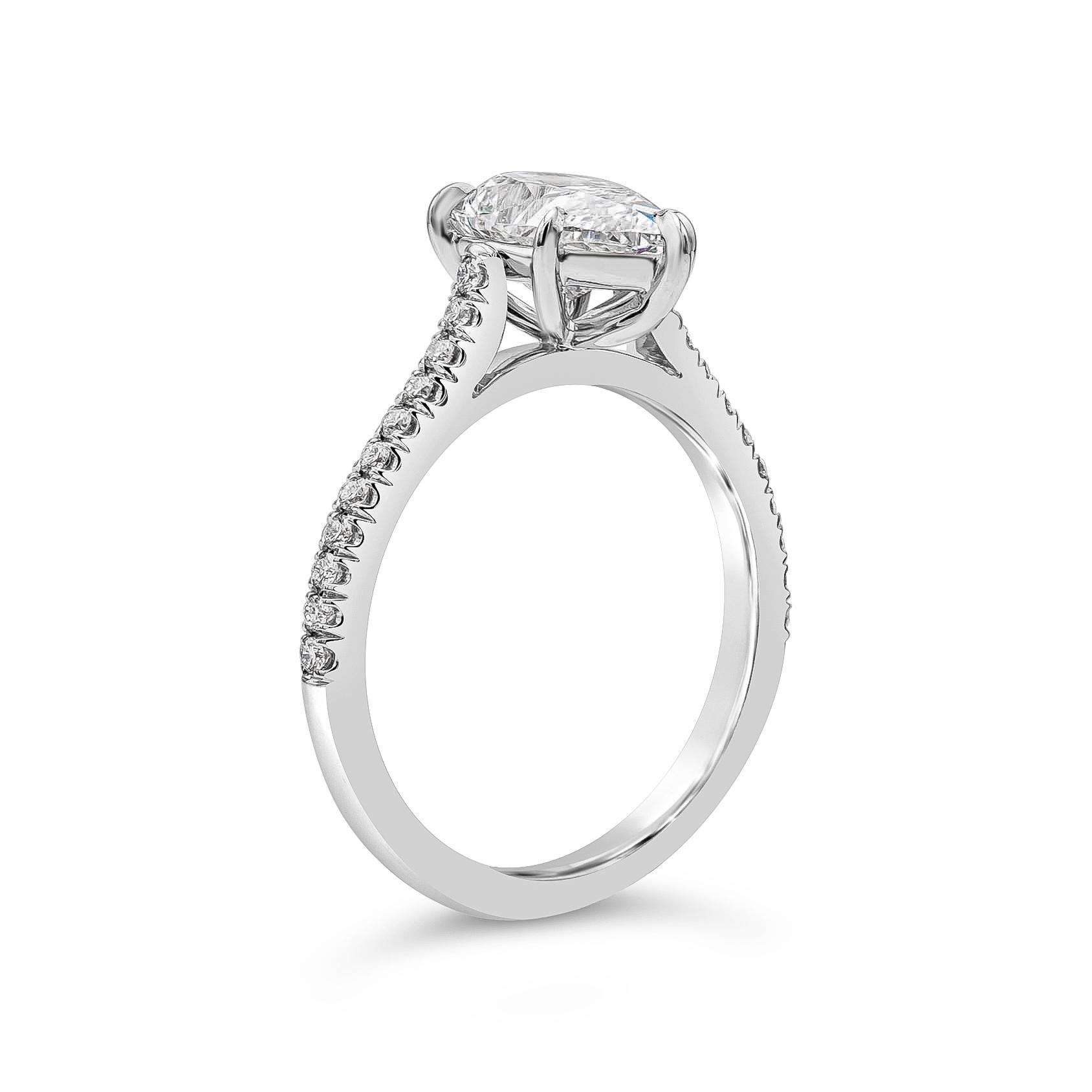 A classic and timeless engagement ring style showcasing a 1.84 carats pear shape diamond certified by GIA as E color and SI1 in clarity, set in a five prong basket setting and encrusted with 22 brilliant round diamonds on the shank of the ring