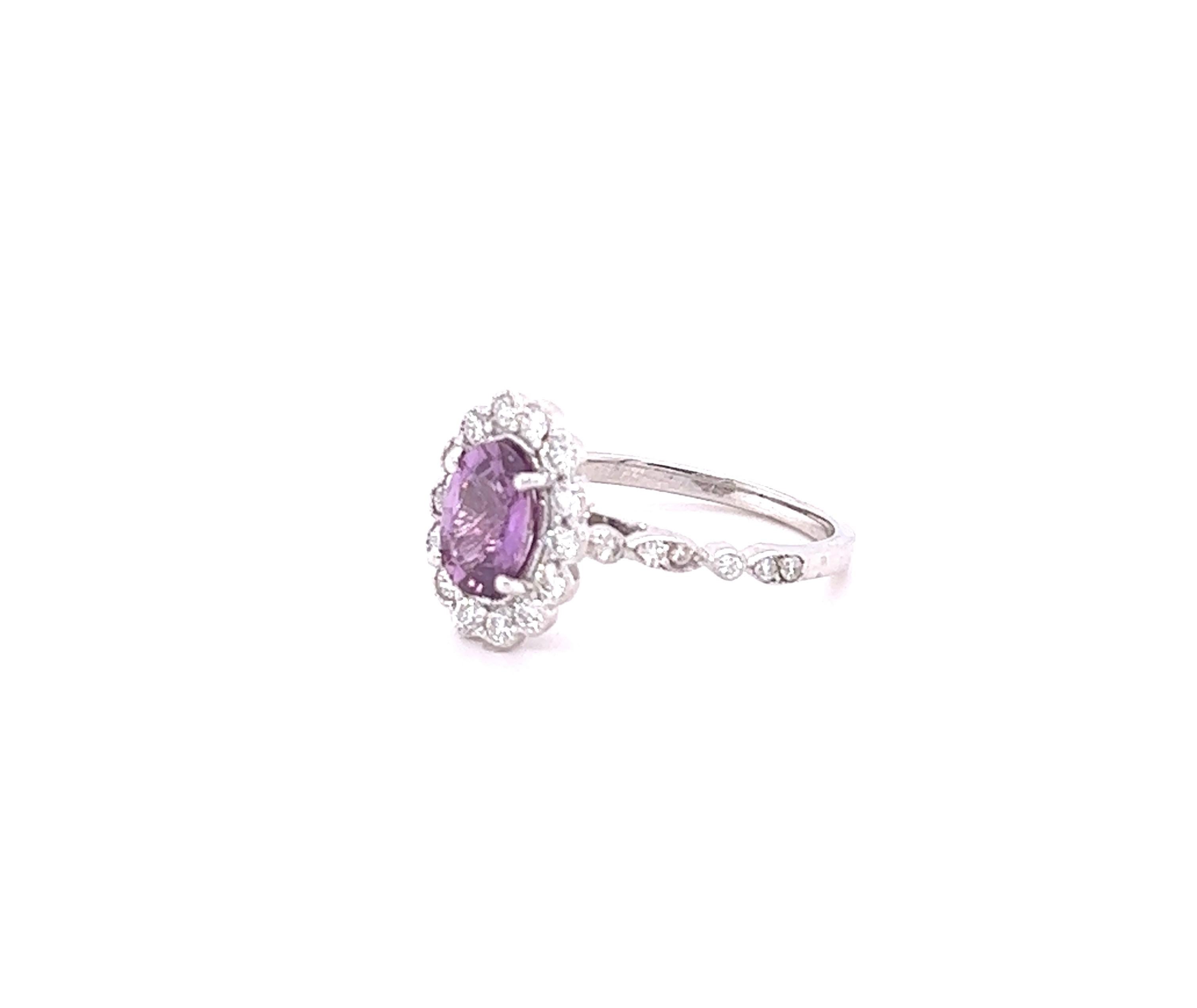 This beautiful ring has a Natural Oval Cut Purplish Pink Sapphire that weights 1.36 Carats. 

The ring is embellished with 26 Round Cut Diamonds that weigh 0.48 Carats with a clarity and color of VS/H. 
The total carat weight of the ring is 1.84