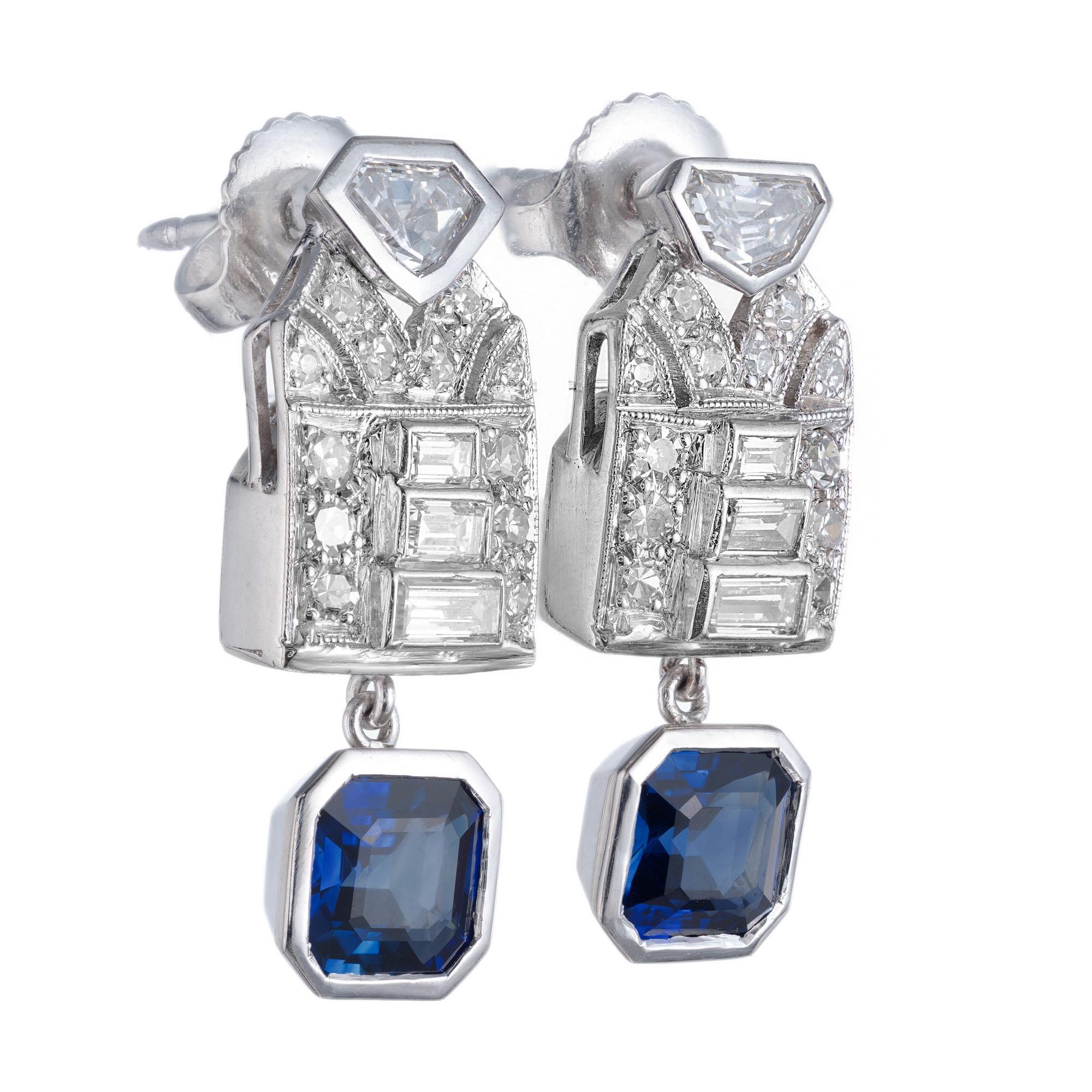 1915 Art Deco sapphire and diamond dangle earrings. Set with shield, baguette and round diamonds in platinum with bezel set blue octagonal step cut sapphire dangles. Both GIA certified natural no heat.

2 octagonal blue sapphires, VS-SI approx.