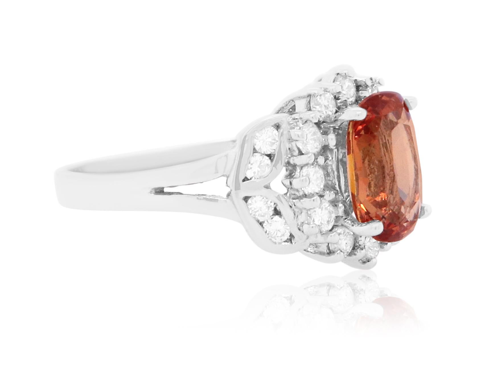 Material: 18K White Gold 
Center Stone Details: 1 Cushion Cut Padparadscha Sapphire at 1.86 Carats - Measuring at 8.49 x 5.65 x 3.81 mm
Diamond Details: 20 Brilliant Round White Diamonds at 0.46 Carats- Clarity: SI  / Color: H-I
Complimentary sizing