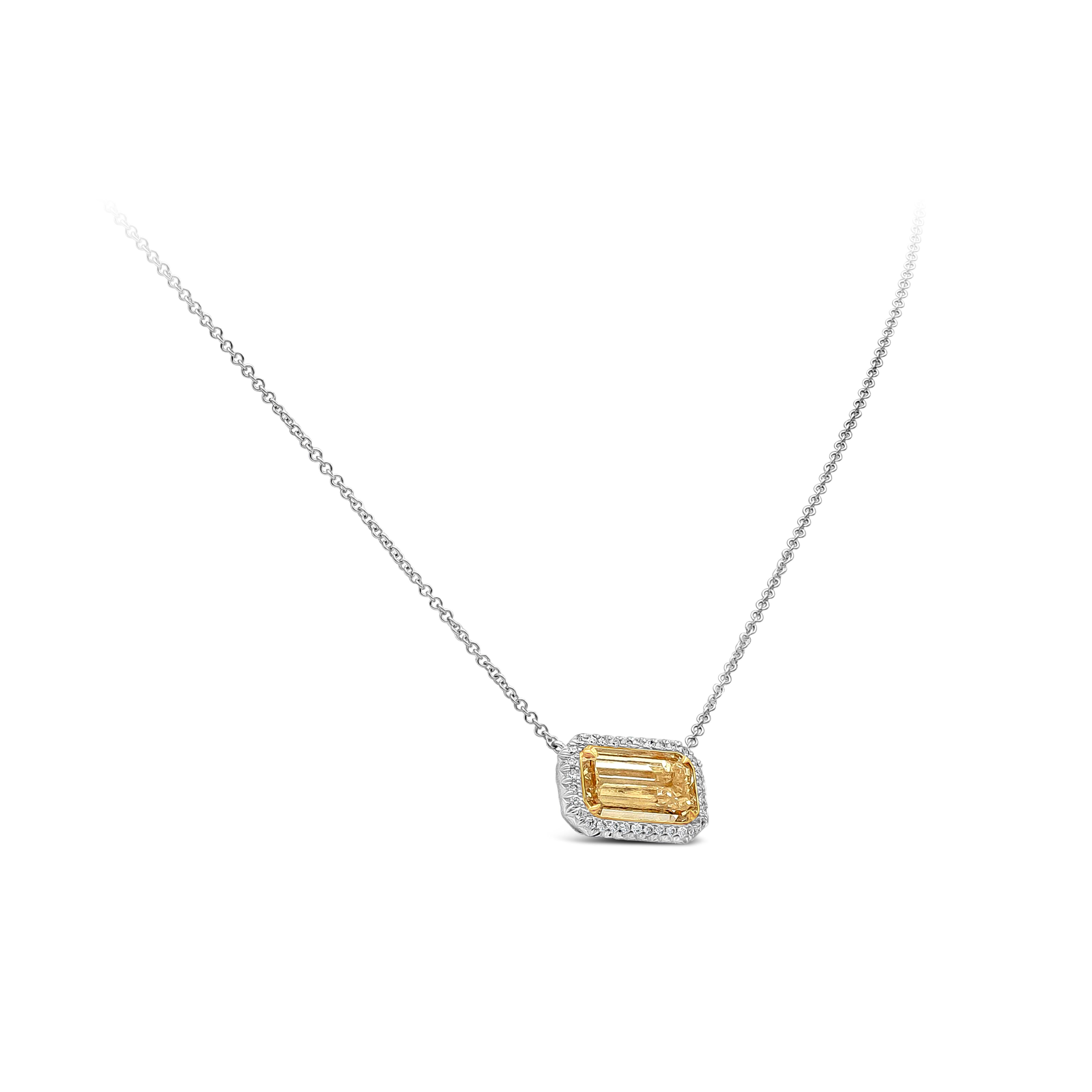 A beautiful pendant necklace showcasing a 1.86 carats emerald cut diamond certified by GIA as W-X color and VS1 in clarity. Surrounded by a a row of round brilliant diamonds weighing 0.18 carats total, F color and VS in clarity. Suspended on an 18