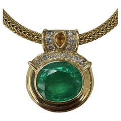 GIA Certified 18.80cts. Oval Emerald and Diamond Pendant set in 18k Yellow Gold