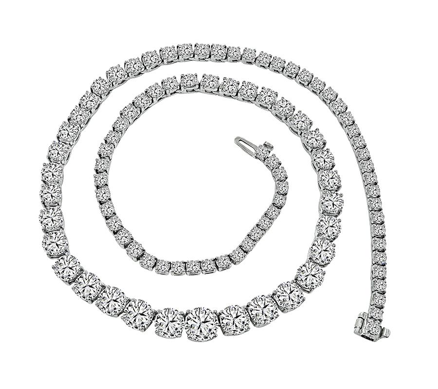 This is an amazing 18k white gold tennis necklace. The necklace is set with sparkling round cut diamonds that weigh 30.87cttw. The 19 large diamonds are GIA certified that weigh 18.81ct. The rest of the small diamonds weigh 12.06ct. The color of the