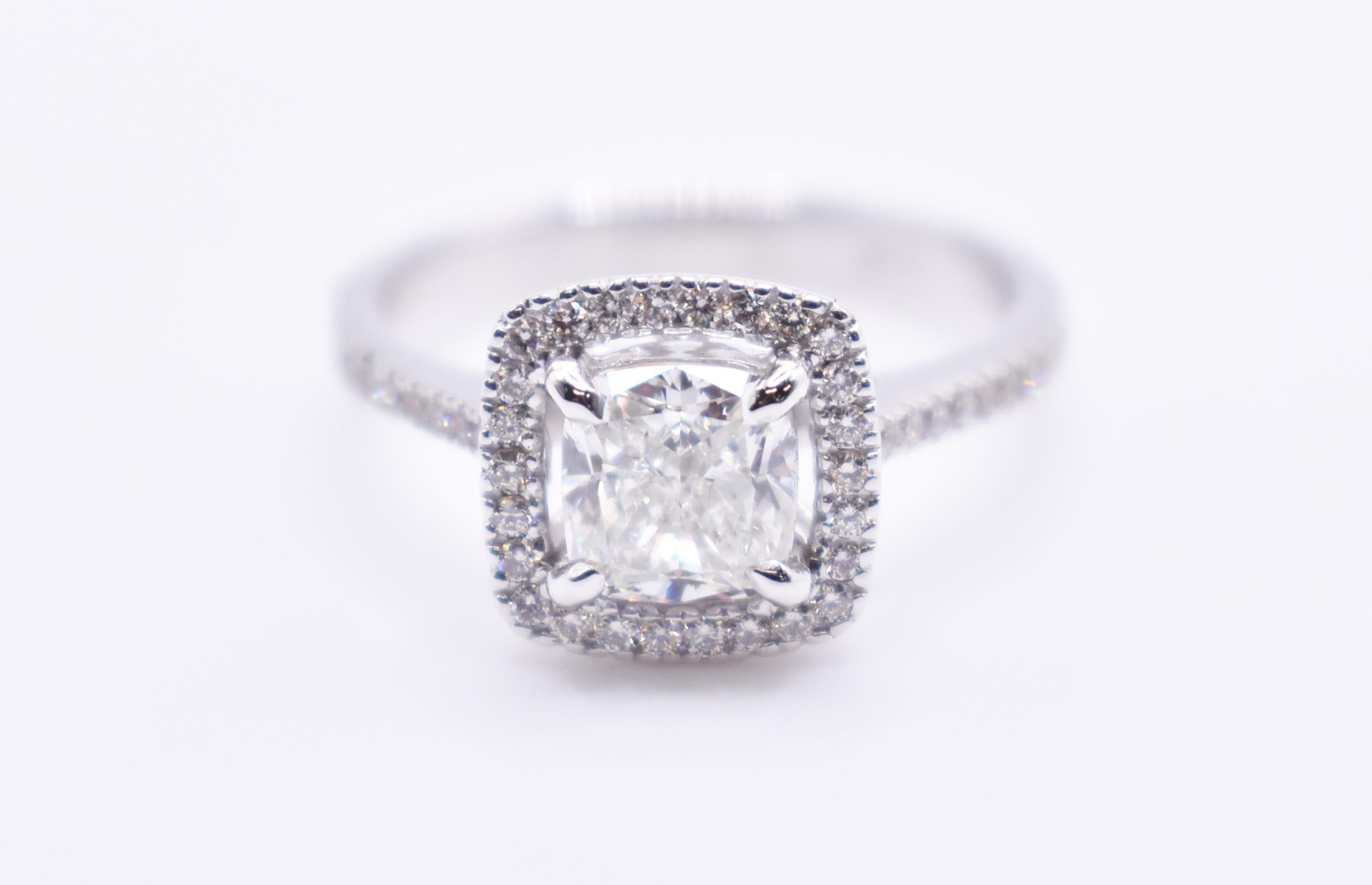On offer for sale is a truly stunning GIA certified 18k white gold cushion cut diamond engagement ring, having a 1.30ct cushion cut diamond to the centre, with a halo of round cut diamonds and pave sides. 

Metal: 18K White Gold
Total Carat Weight: