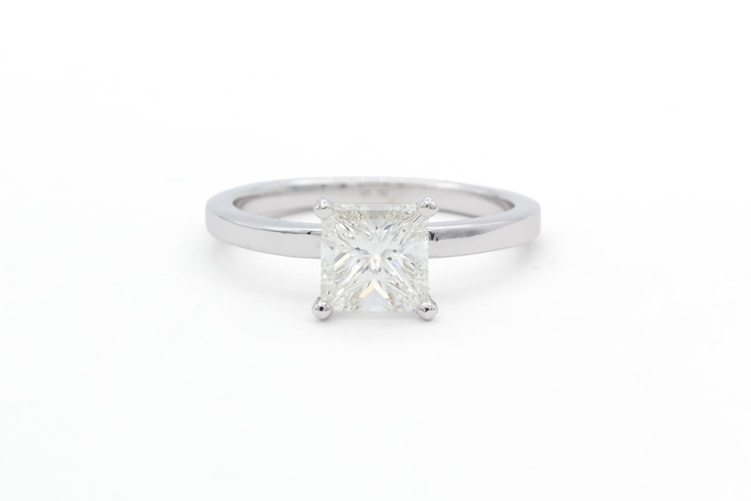 We are pleased to offer this GIA Certified & Laser Inscribed 18k White Gold & Princess Cut Diamond Solitaire Engagement Ring. This beautiful ring features a GIA certified & laser inscribed 1.50ct H/SI2 princess cut diamond set in a classic 18k white