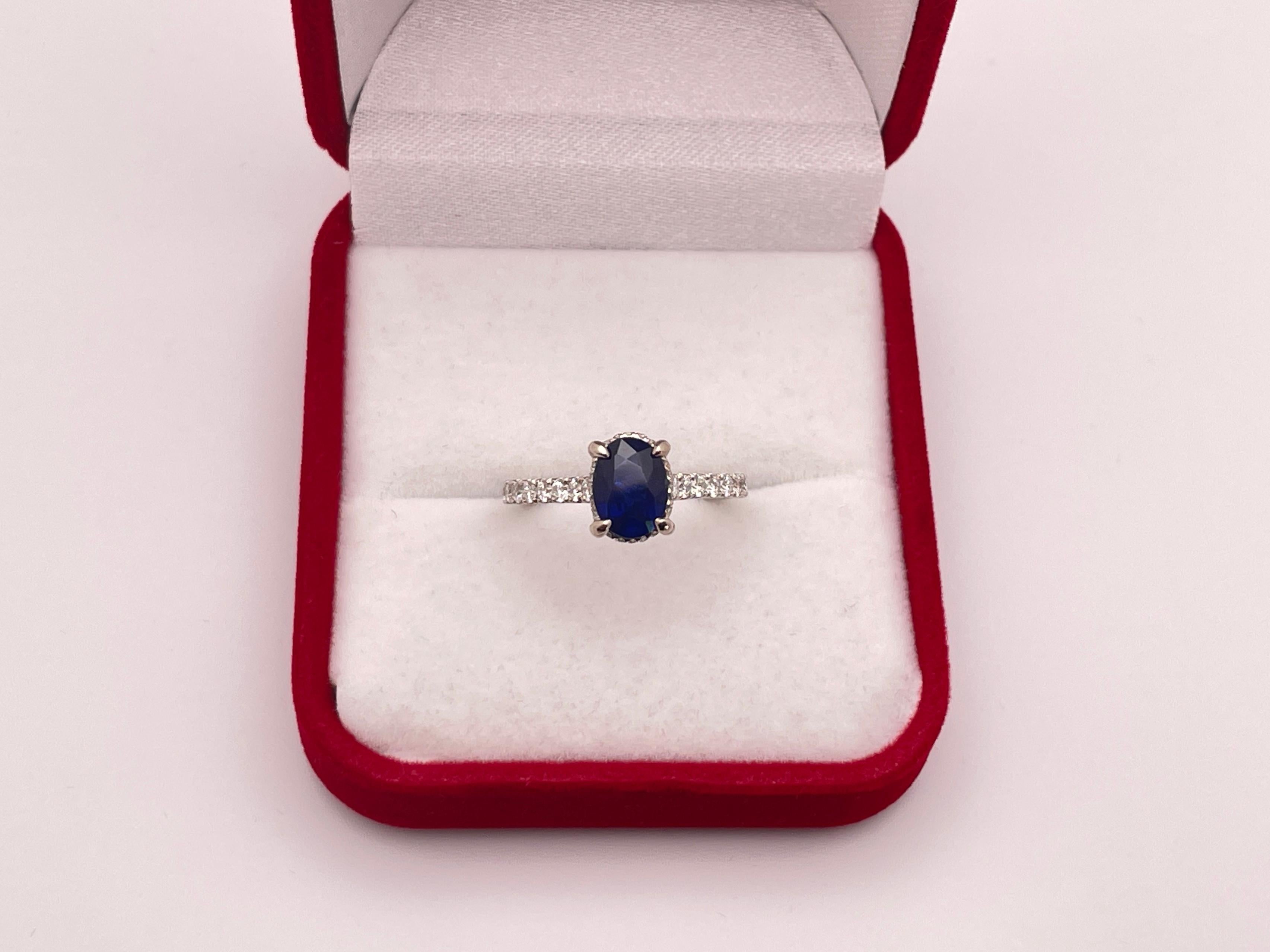 A magnificent 18K white gold natural sapphire (unheated) diamond engagement ring. Centered with a gorgeous, GIA-certified, unheated natural corundum oval-shaped blue sapphire weighing approximately 1.12 CT, and measuring 7.81 x 5.84 x 3.39 mm, (GIA