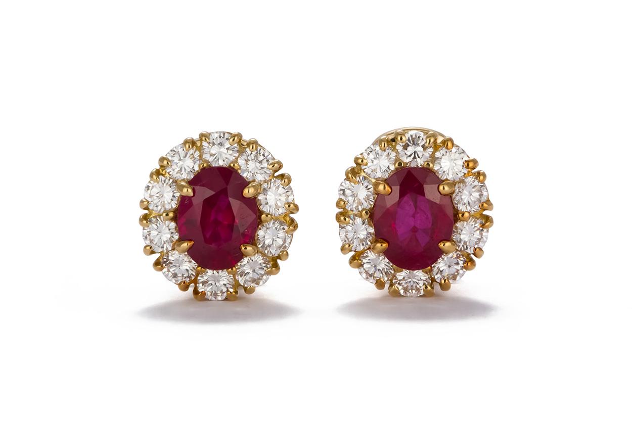 We are pleased to offer these GIA Certified 18k Yellow Gold Diamond Halo & Burma Ruby Earrings. These stunning earrings feature approximately 4.00ctw GIA certified natural Burma oval cut rubies accented by approximately 2.00ctw F-G/VS round