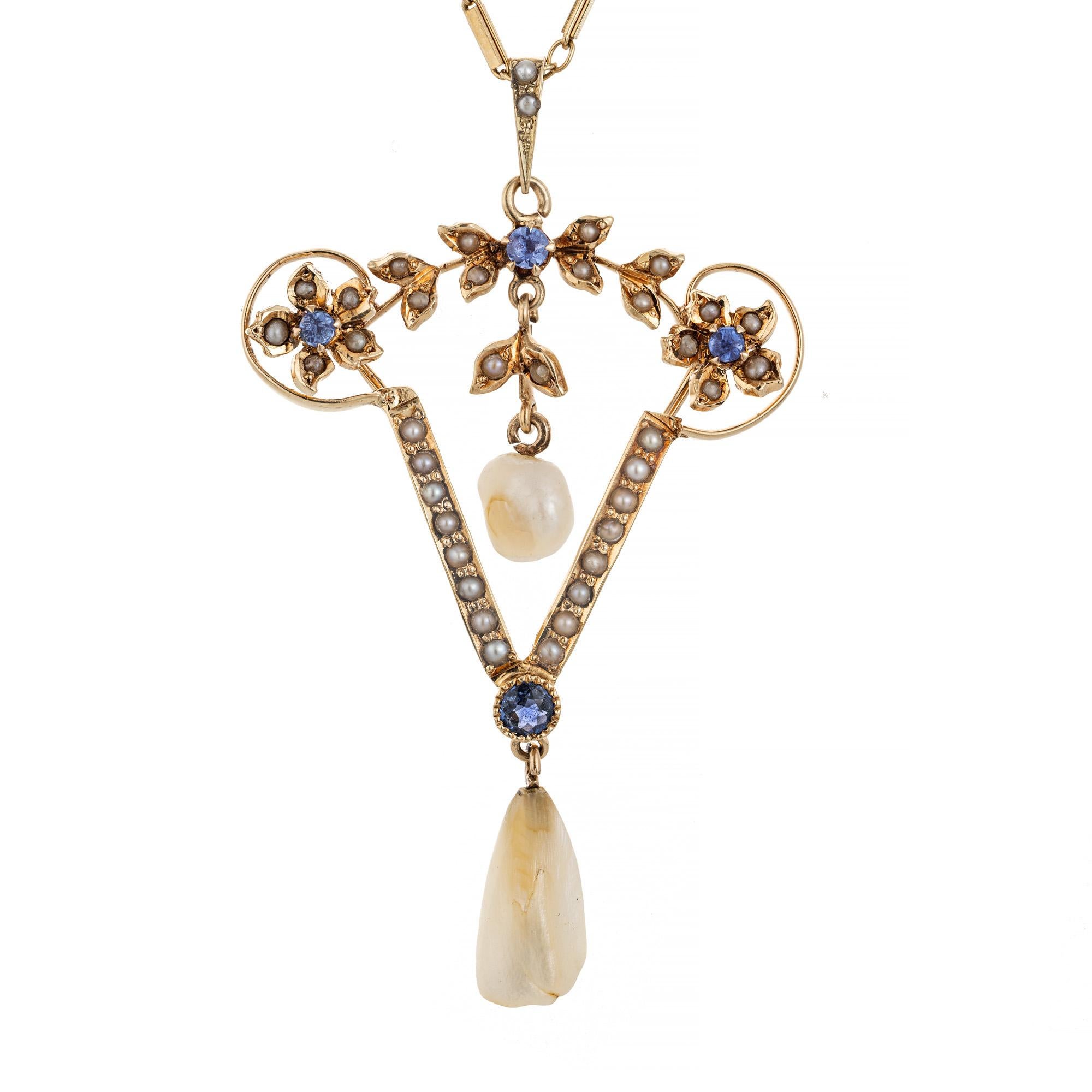 1910 Pearl and Sapphire pendant necklace. GIA certified natural untreated round sapphires in a 14k yellow gold pendant setting accented with 2 natural baroque freshwater pearls, with a 19 inch 14k yellow gold chain. One pearl and one sapphire were