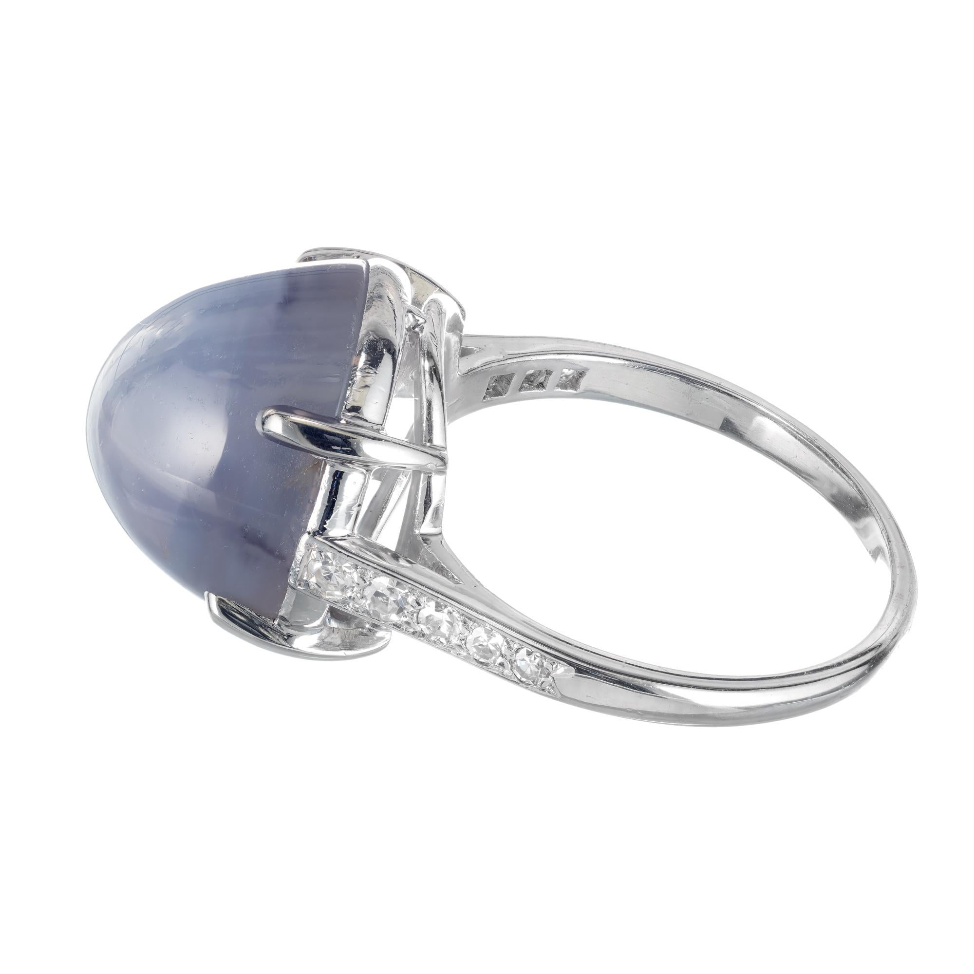 Star sapphire and diamond cabochon engagement ring. Circa 1960's translucent light violet blue star sapphire diamond in a platinum setting with round accent diamonds. 

1 oval cabochon violet blue star sapphire, Approximate 19.0cts GIA Certificate #