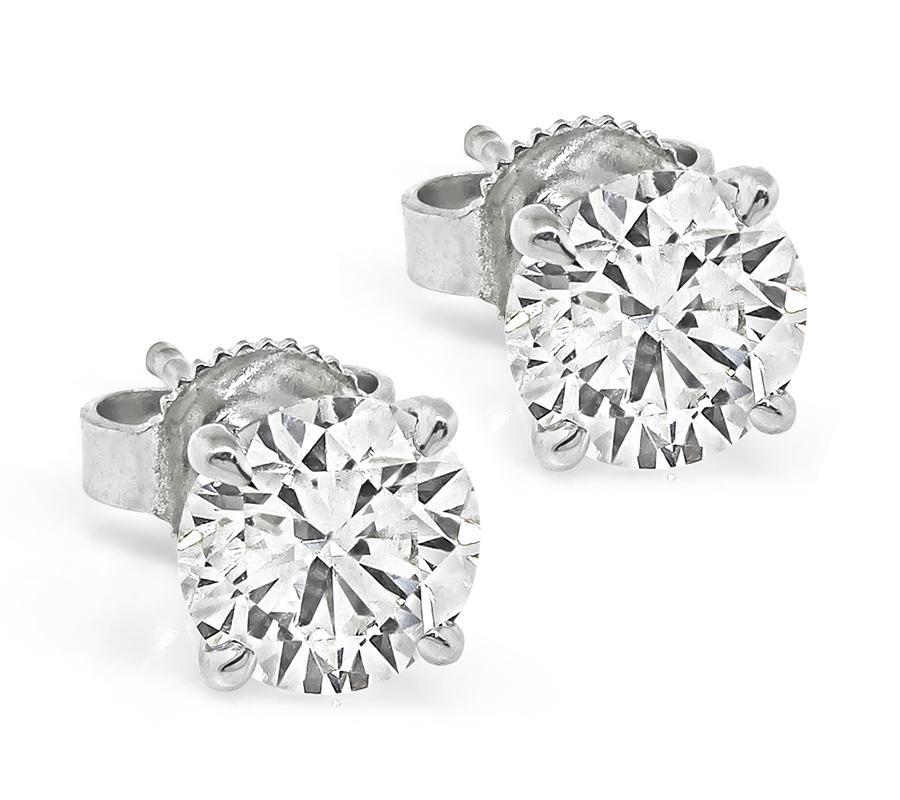 This is an elegant pair of diamond 14k white gold stud earrings. The earrings are set with sparkling GIA certified round cut diamonds that weigh 0.96ct and 0.96ct. The color of the diamonds is I with SI1 clarity and J with SI1 clarity. The total