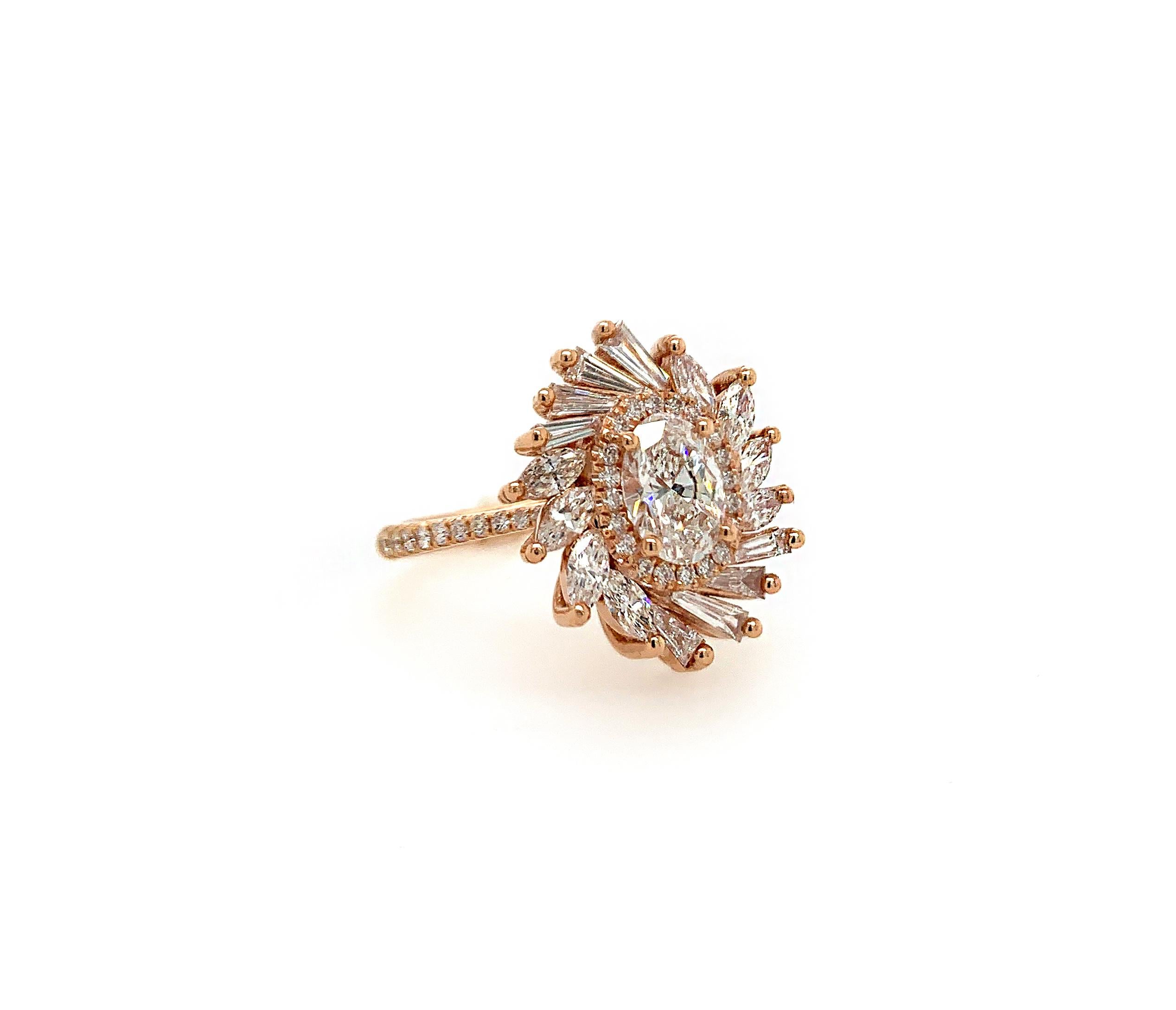 This beautiful ring flaunts a 0.76 carat oval-cut white diamond surrounded by a diamond halo and set atop a bed of marquise and tapered baguette diamonds. This ring is truly unique and its design was inspired by the feathers of an elegant bird's