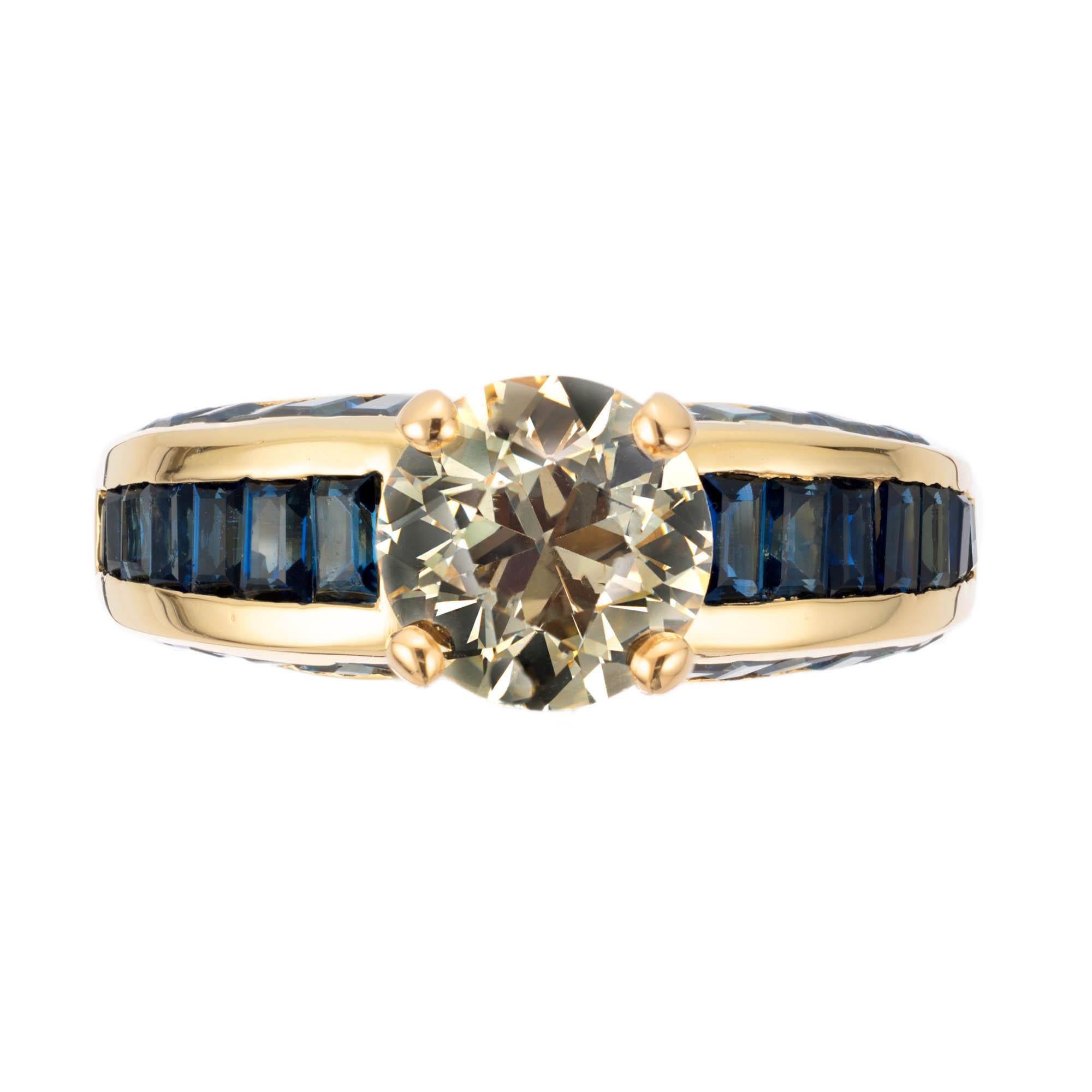 Old European brilliant cut diamond and sapphire engagement ring. Natural fancy light golden yellow GIA certified accented with 42 step cut graduated sapphires in a 18k yellow gold setting. 

1 old European cut natural fancy light brown yellow