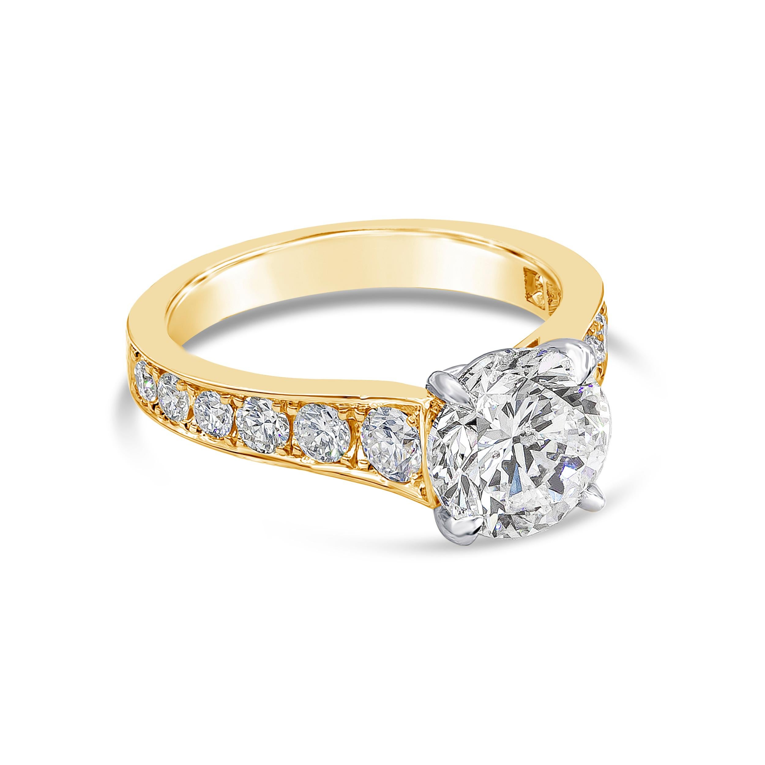 A timeless engagement ring style showcasing a 1.97 carats round brilliant diamond, set in a tapered yellow gold mounting accented with round diamonds. Accent diamonds weigh 0.75 carats total. GIA certified the center diamond as G color, I1 clarity.