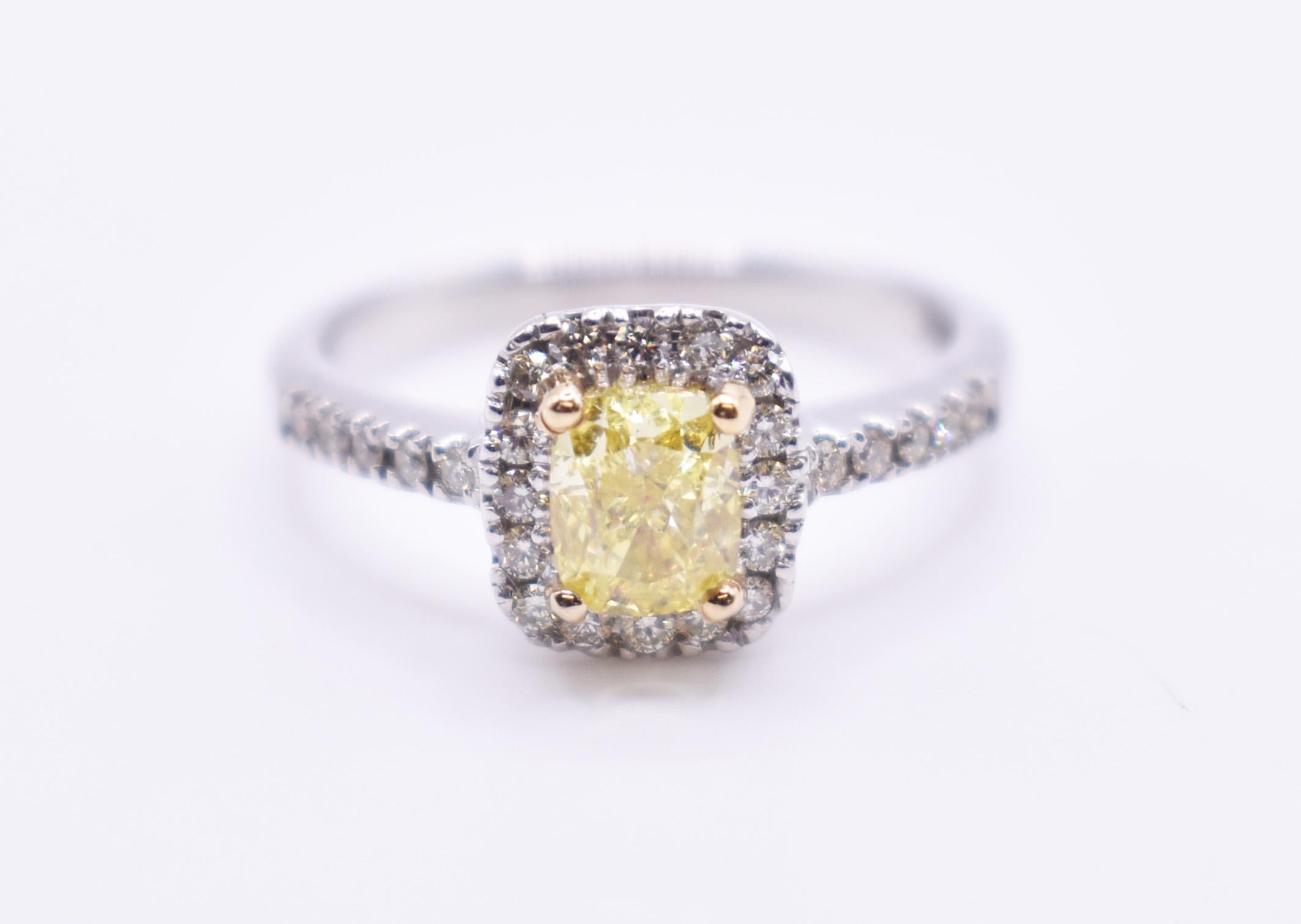 On offer for sale is an exquisite GIA certified 1ct fancy intense yellow diamond halo engagement ring, having a 1ct cushion cut fancy intense yelow diamond to the centre, surrounded by a halo of of round cut diamonds, with pave sides. 

Metal: 18k