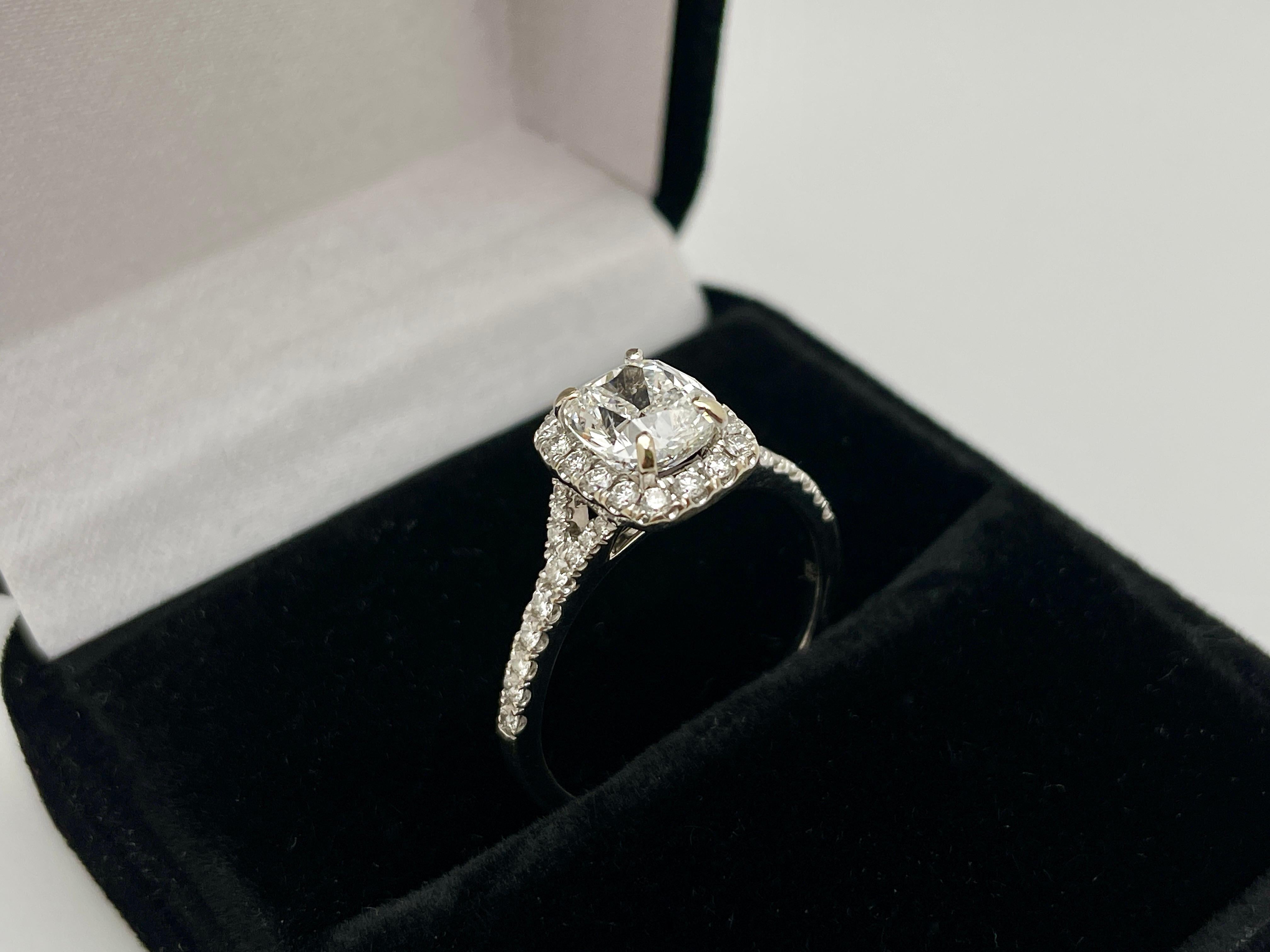An original GIA certified 18K white gold diamond engagement ring signed Ed.B. Centered with one magnificent 1.52 CT, G color, SI1 clarity, cushion cut  diamond which is accompanied by a GIA certificate. Set with approximately 40 round brilliant cut