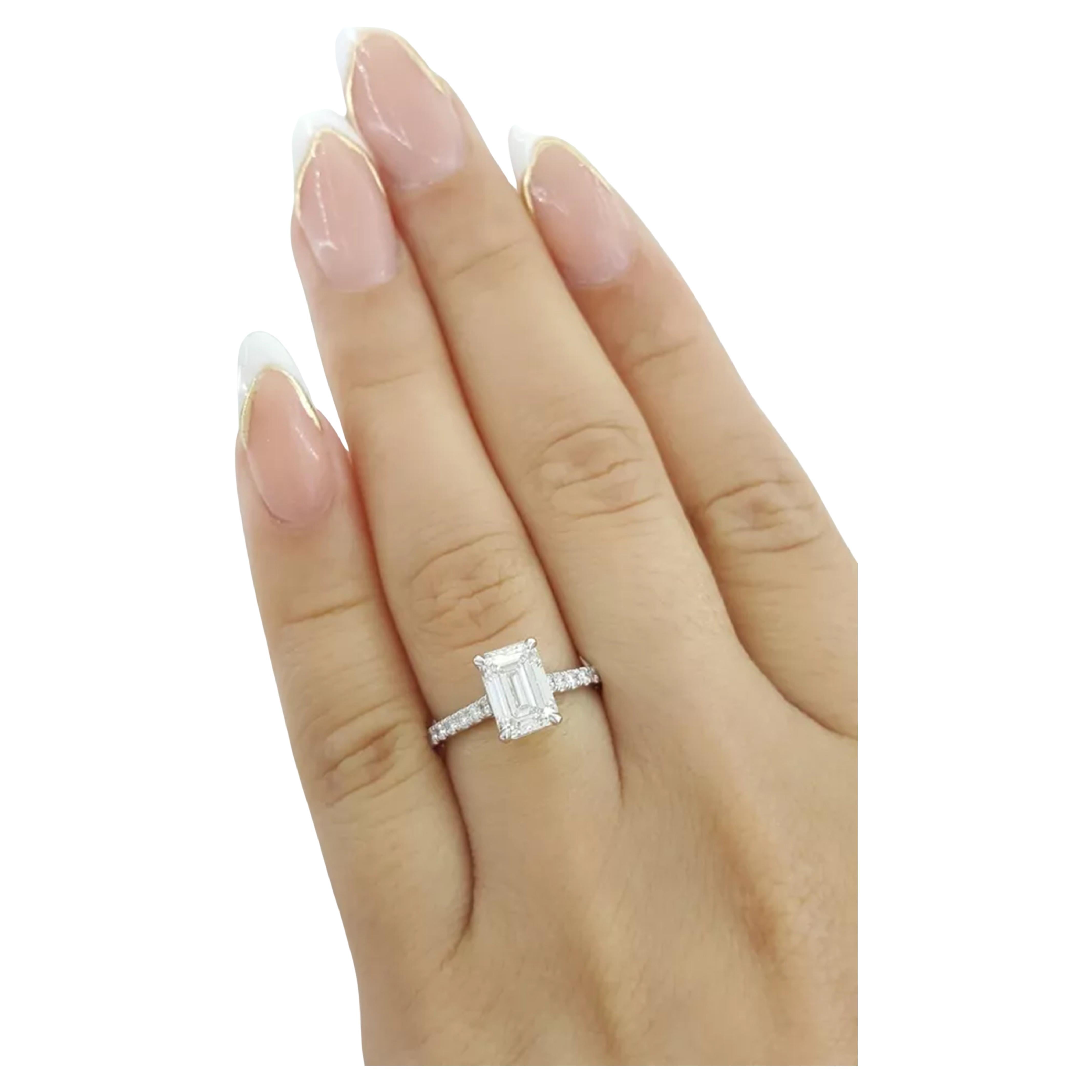 This stunning engagement ring features a GIA certified 2.01 carat emerald cut diamond as it's centerpiece, showcasing timeless elegance and sophistication. 

With an exceptional D color grade, the diamond is completely colorless, offering
