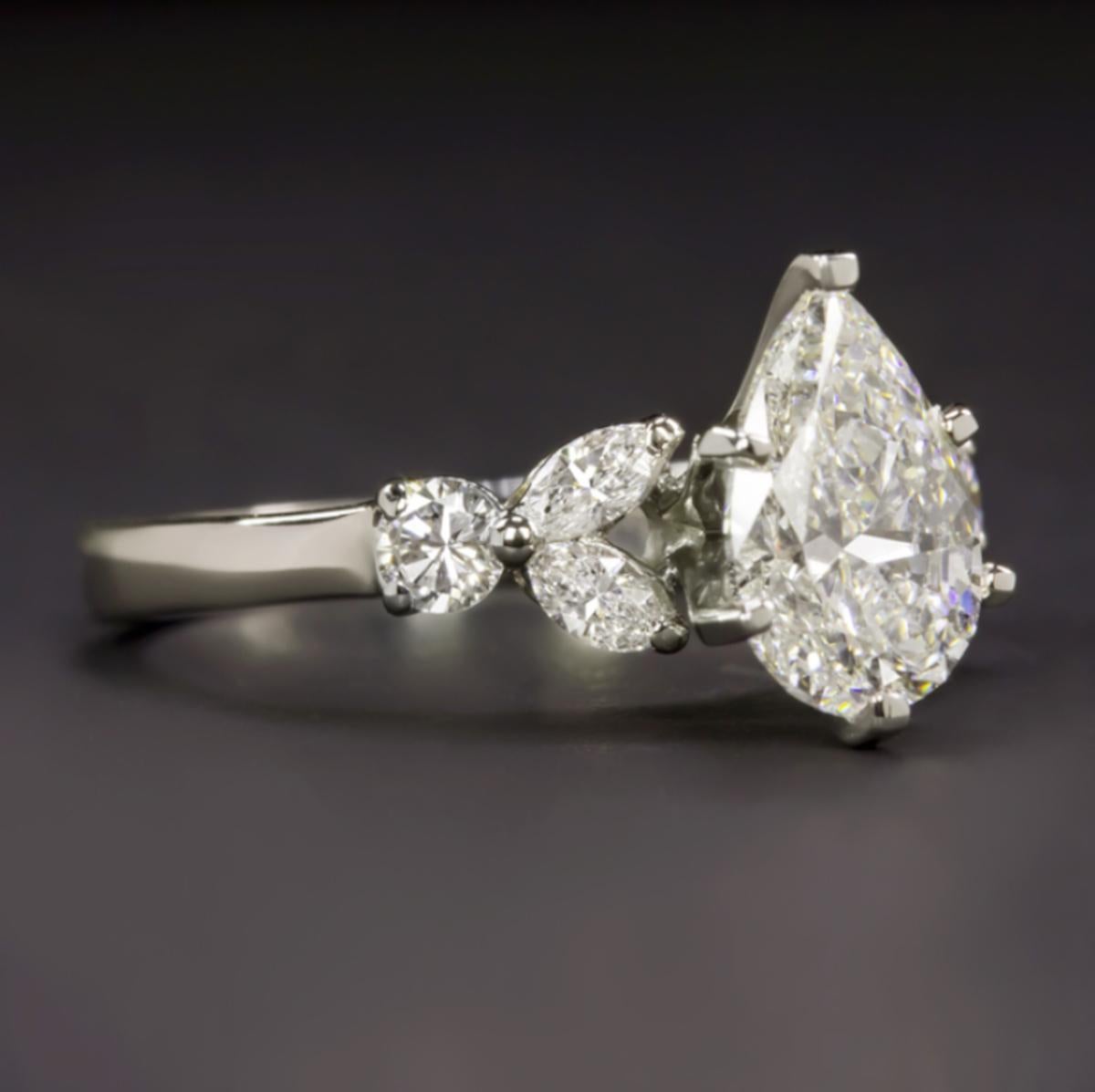 Ring with a 1.53 carat GIA certified pear cut main diamond.
The main stone is G in color and SI2 in clarity; it is a beautiful stone with no fluorescence.
The side stones are two round cut diamonds and four marquise cut diamonds; they are E-F  in